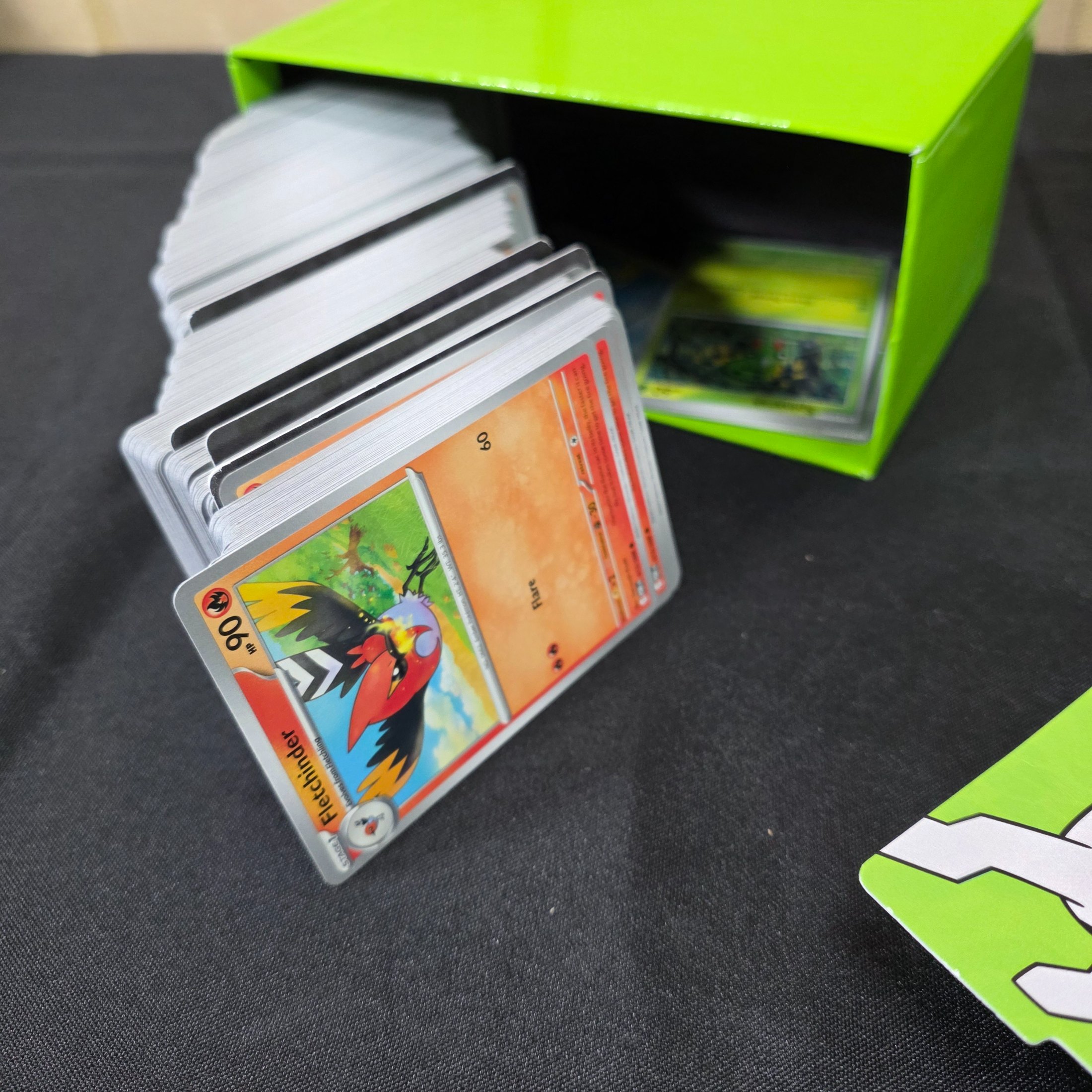 A green and black Pokémon Trading Card Game 'Perfect Order' storage box filled with assorted bulk cards. - View 5