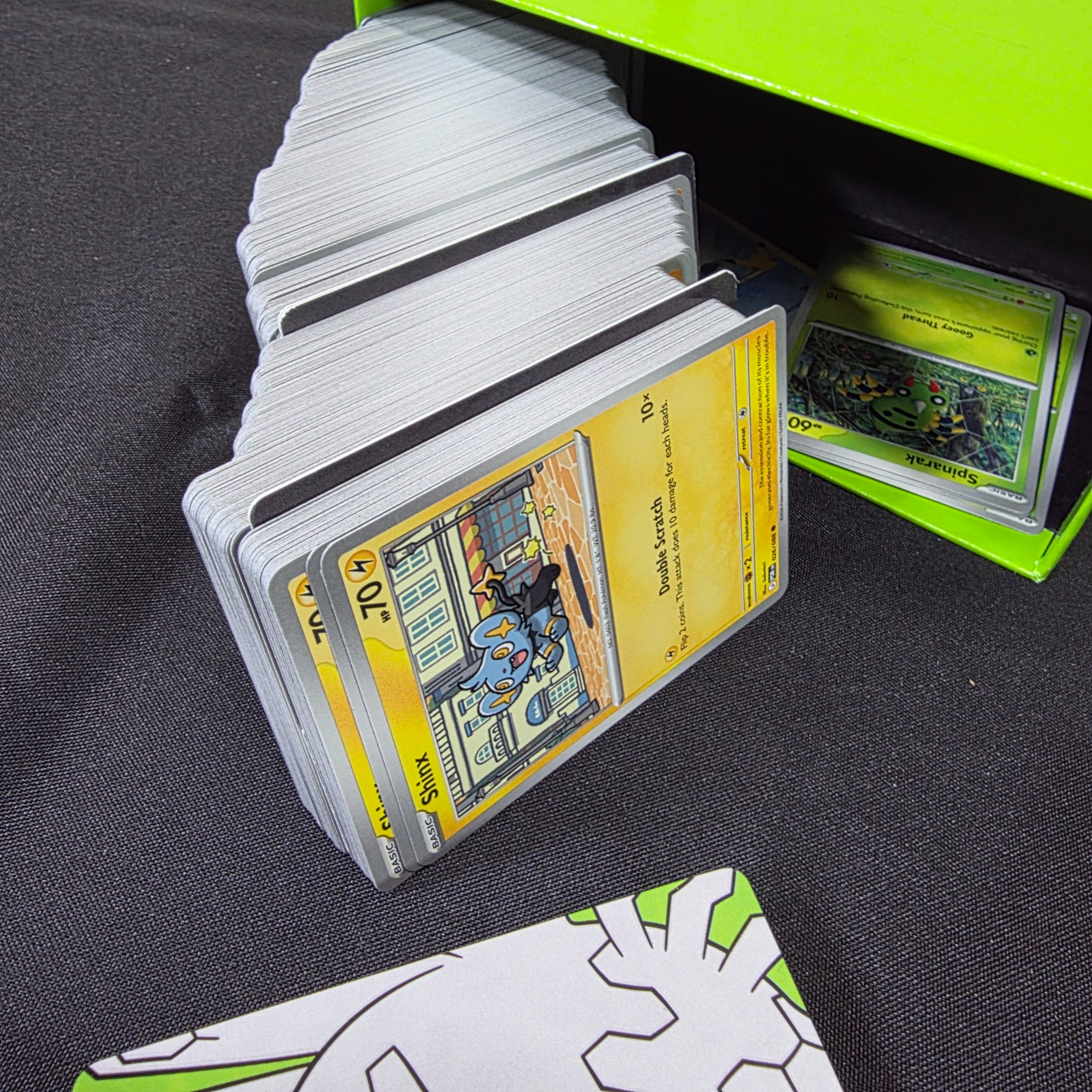 A green and black Pokémon Trading Card Game 'Perfect Order' storage box filled with assorted bulk cards. - View 7