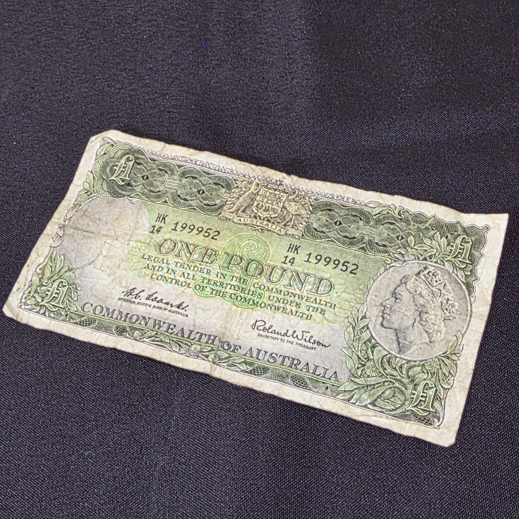 A vintage Australian One Pound banknote featuring Queen Elizabeth II, issued by the Commonwealth of Australia during the mid-20th century.