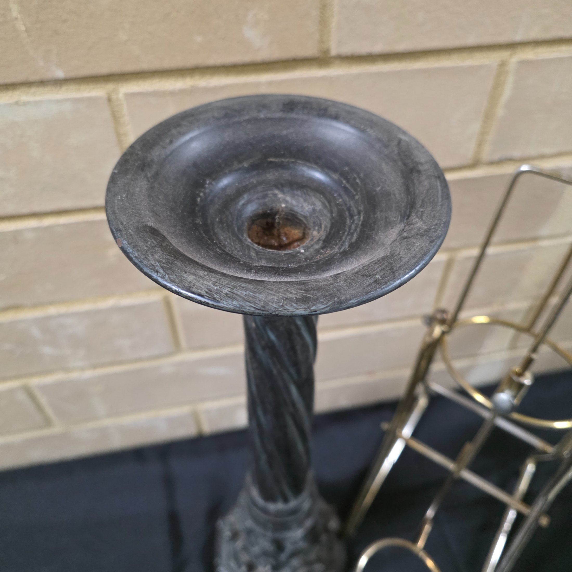 A varied collection of vintage homewares featuring a dark metal candlestick, a silver-plated candelabra, a mirrored tray, and several other decorative and functional pieces. - View 3