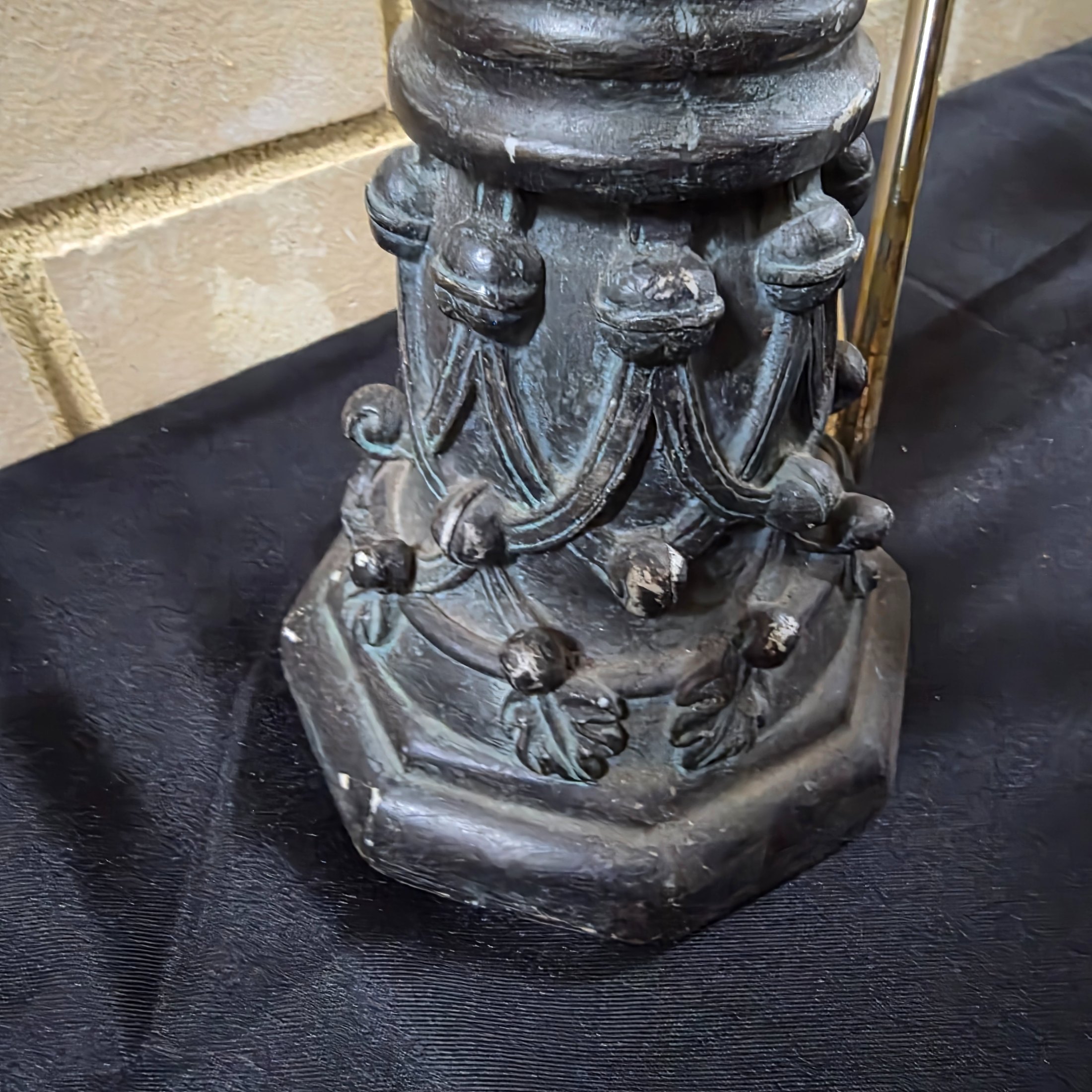 A varied collection of vintage homewares featuring a dark metal candlestick, a silver-plated candelabra, a mirrored tray, and several other decorative and functional pieces. - View 4