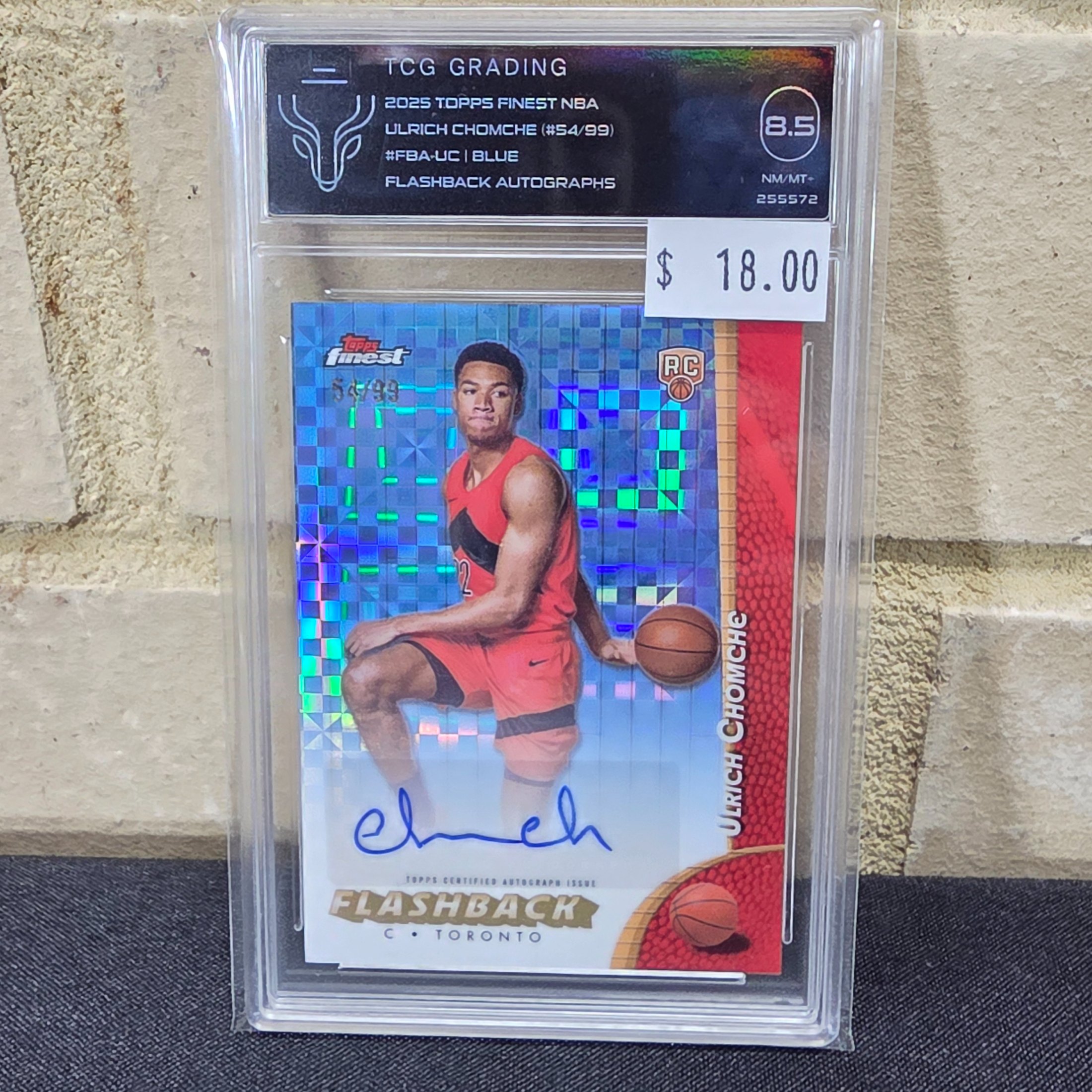 A professionally graded 2025 Topps Finest NBA basketball trading card featuring Ulrich Chomche, numbered 54 of 99, with a Flashback Autograph and a Blue Parallel, encapsulated by TCG Grading with a grade of 8.5 NM/MT-.