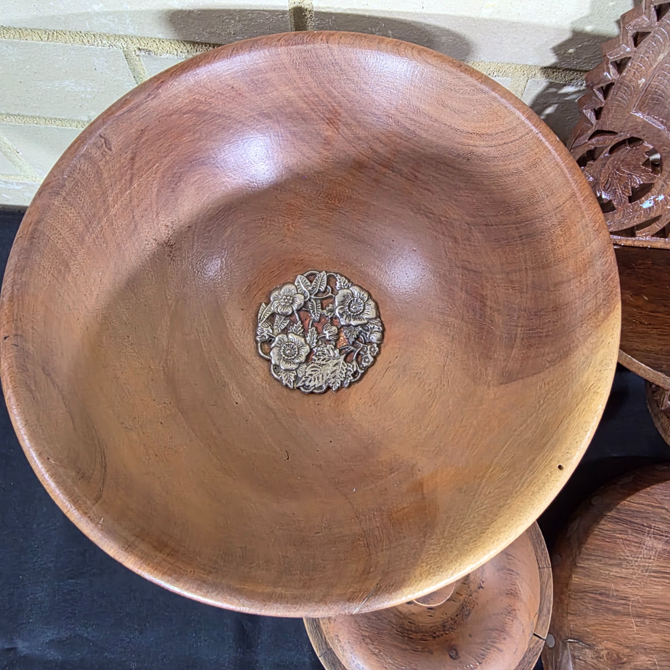 A collection of vintage wooden homewares including a pedestal bowl, lidded container, carved monkey figure, candlestick, wall shelf, and a round trivet. - View 3