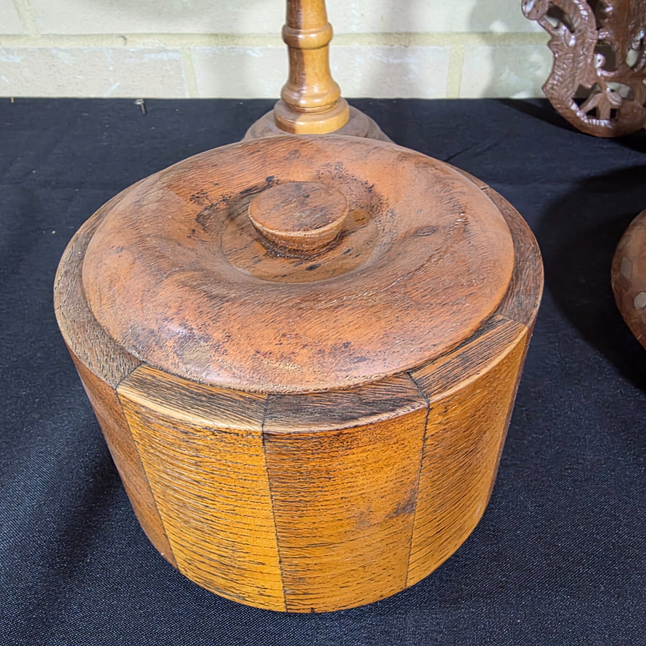 A collection of vintage wooden homewares including a pedestal bowl, lidded container, carved monkey figure, candlestick, wall shelf, and a round trivet. - View 4