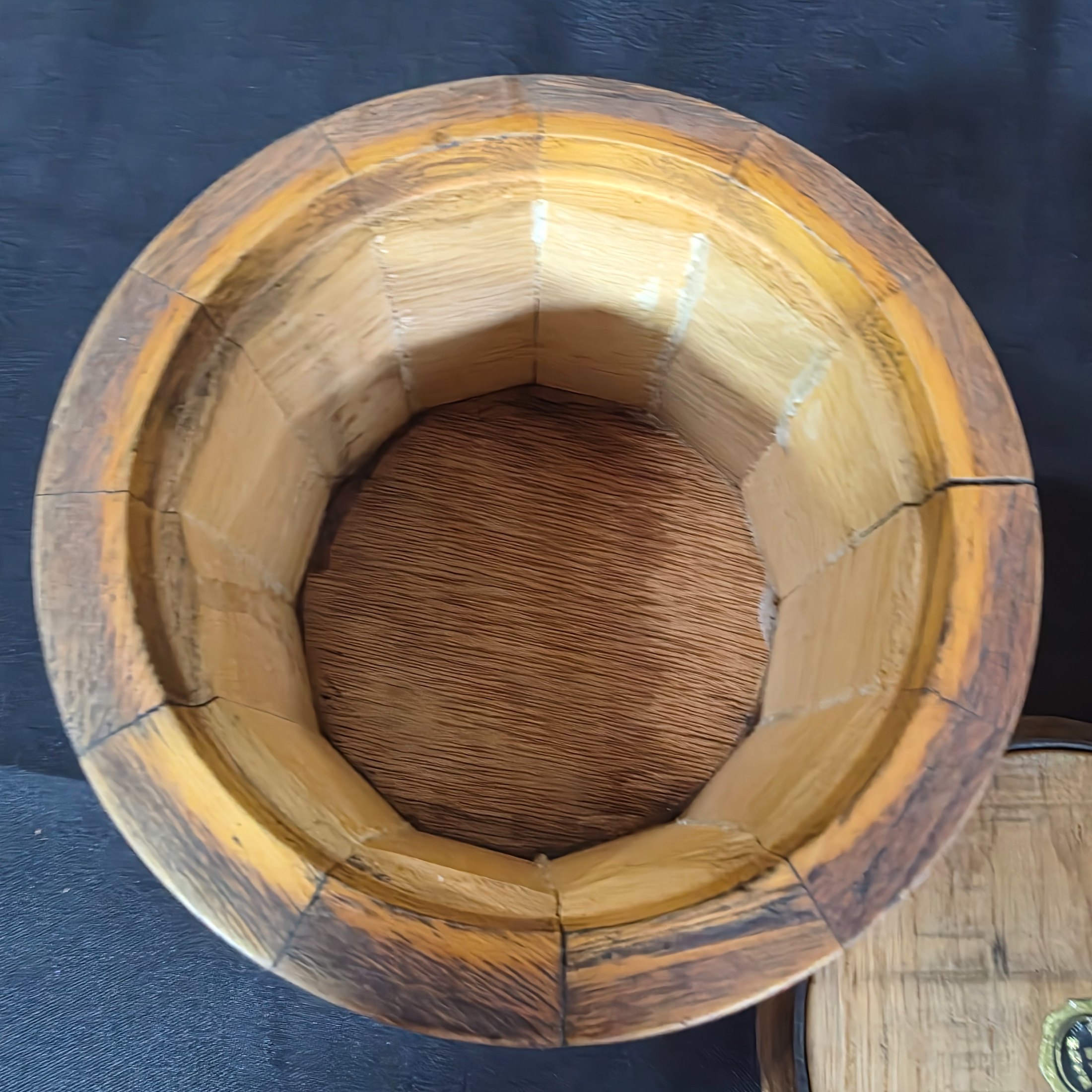 A collection of vintage wooden homewares including a pedestal bowl, lidded container, carved monkey figure, candlestick, wall shelf, and a round trivet. - View 7