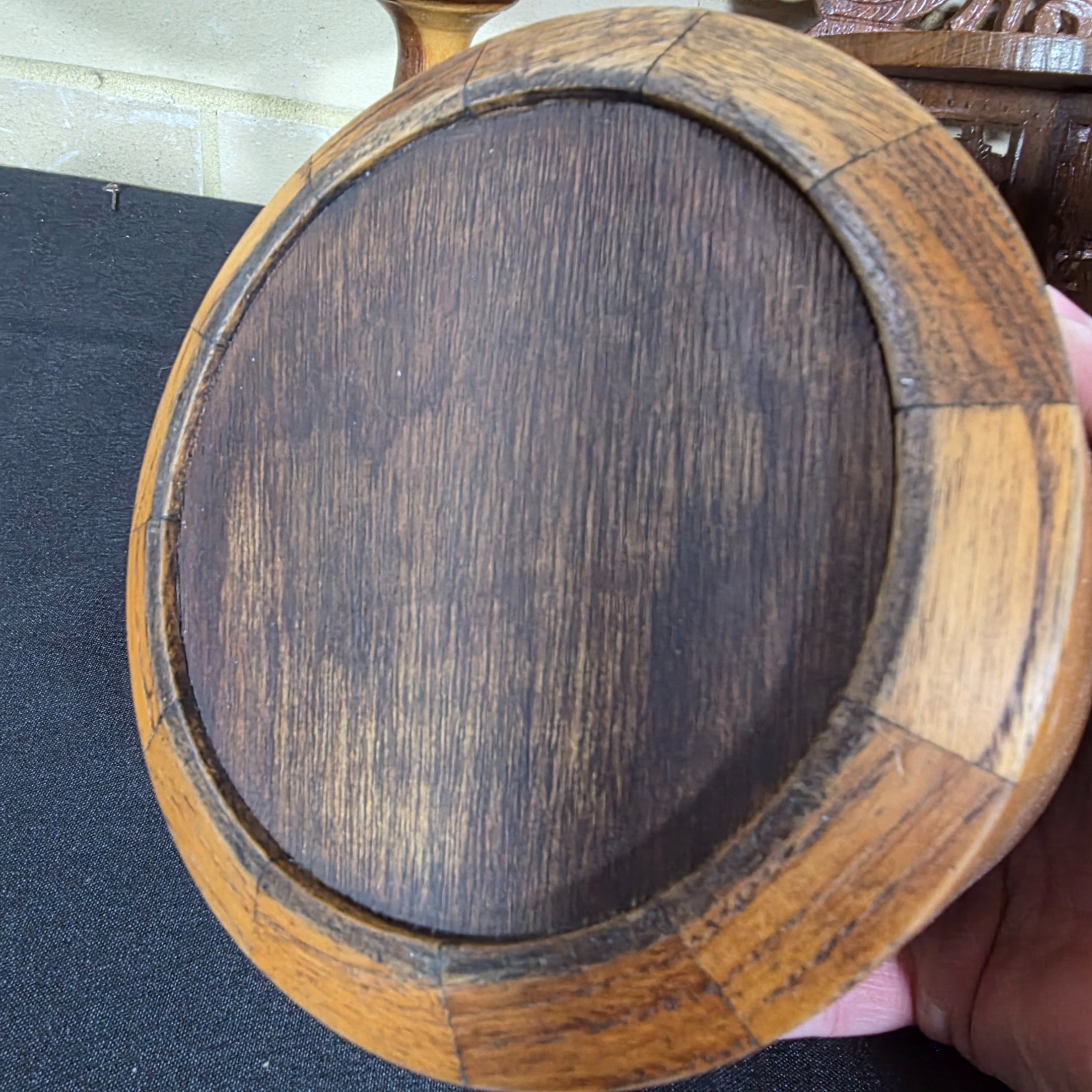 A collection of vintage wooden homewares including a pedestal bowl, lidded container, carved monkey figure, candlestick, wall shelf, and a round trivet. - View 8