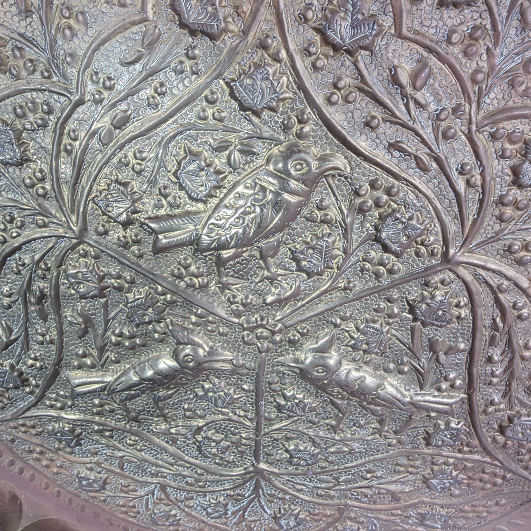 A collection of four assorted decorative metal plates and trays, featuring various embossed and etched designs, suitable for vintage decor. - View 5