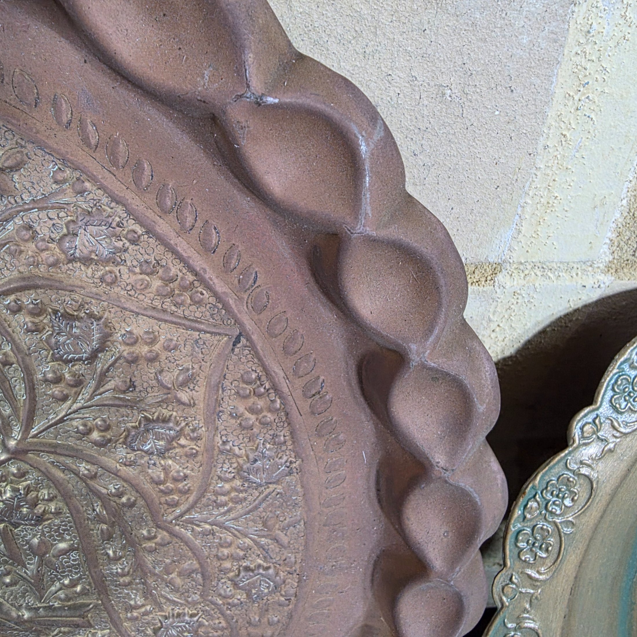 A collection of four assorted decorative metal plates and trays, featuring various embossed and etched designs, suitable for vintage decor. - View 6