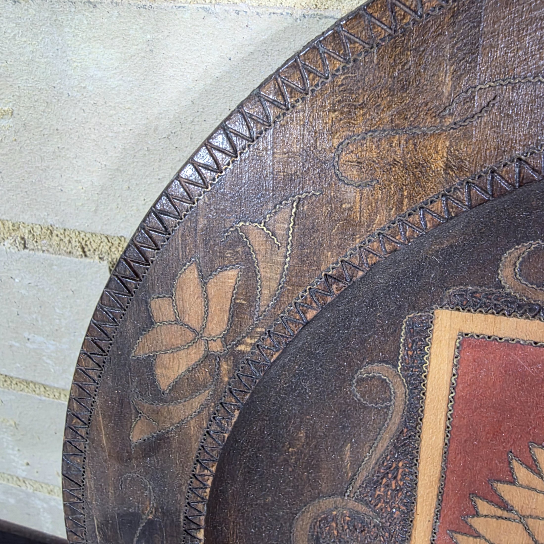 A collection of three vintage decorative wall plates, including a wooden plate with a Polish eagle crest and two copper or bronze plates featuring classical hunting and musical figures. - View 3