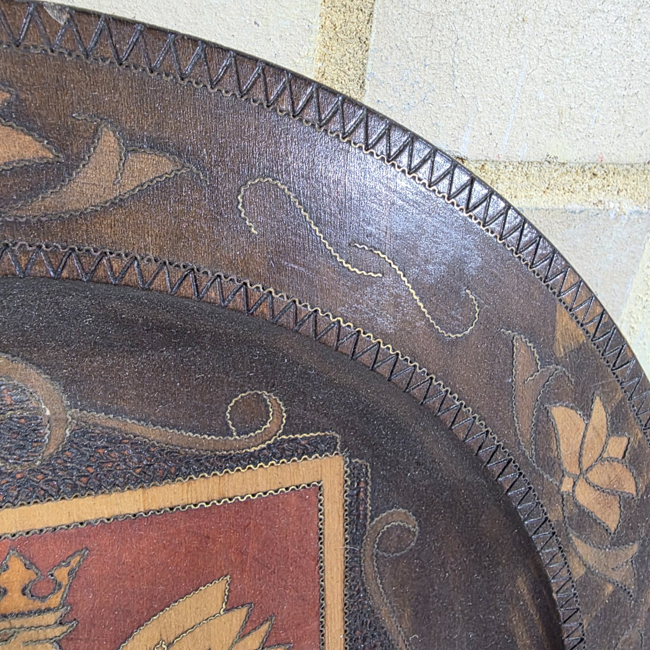 A collection of three vintage decorative wall plates, including a wooden plate with a Polish eagle crest and two copper or bronze plates featuring classical hunting and musical figures. - View 4