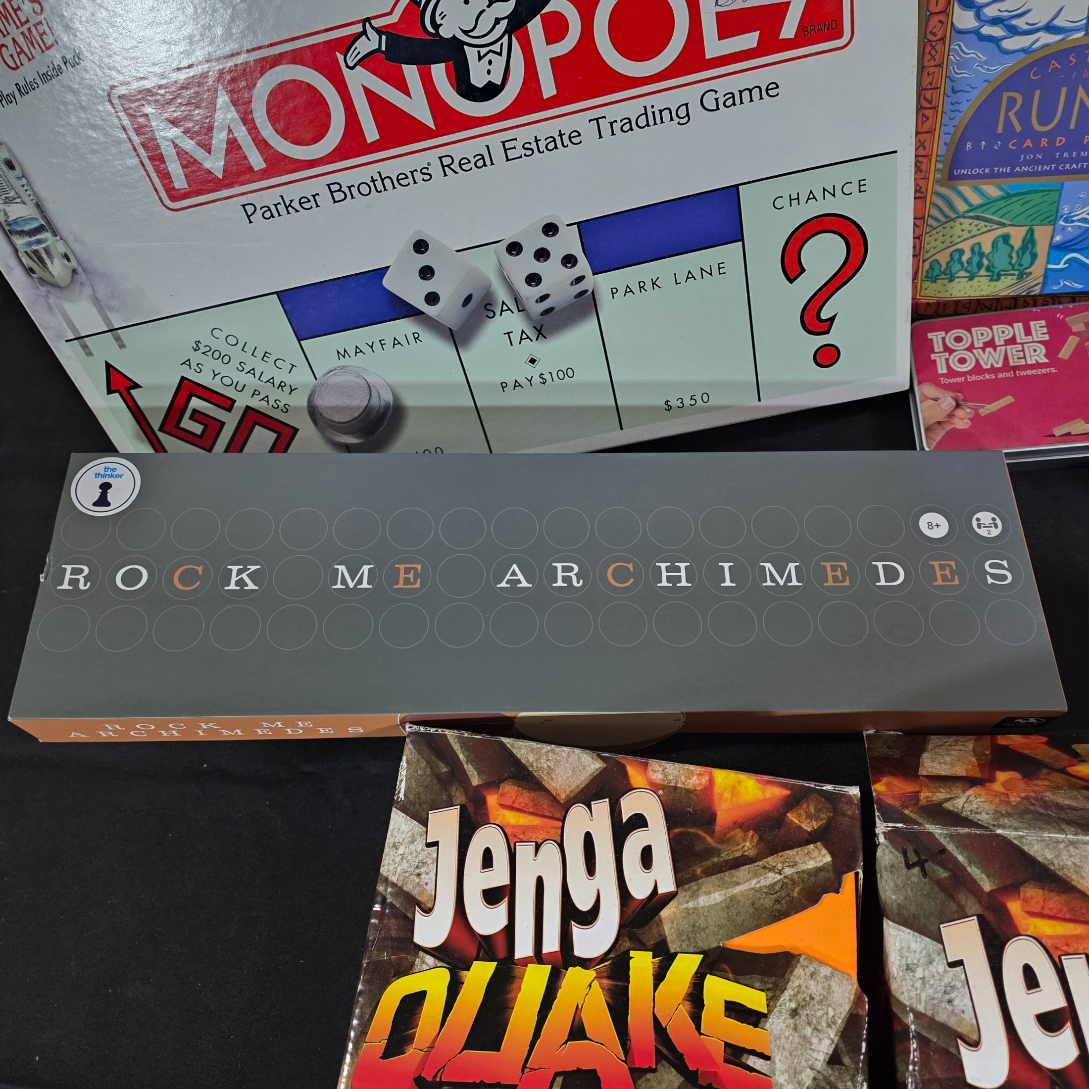 A diverse collection of modern and vintage board games, card games, and puzzles, including Monopoly, Jenga Quake, Mousie Mousie, and a Captain Cook's Voyage puzzle. - View 2