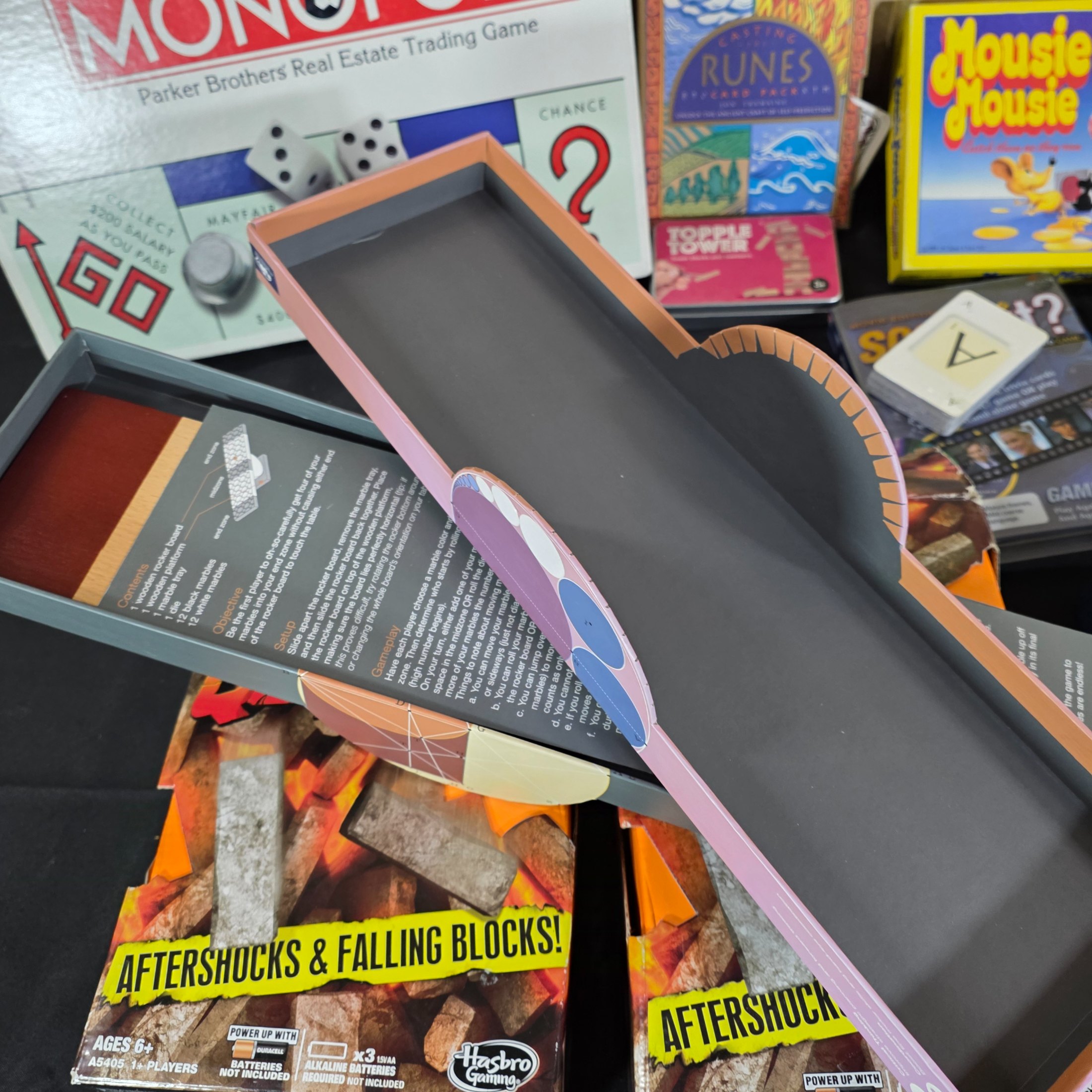 A diverse collection of modern and vintage board games, card games, and puzzles, including Monopoly, Jenga Quake, Mousie Mousie, and a Captain Cook's Voyage puzzle. - View 3
