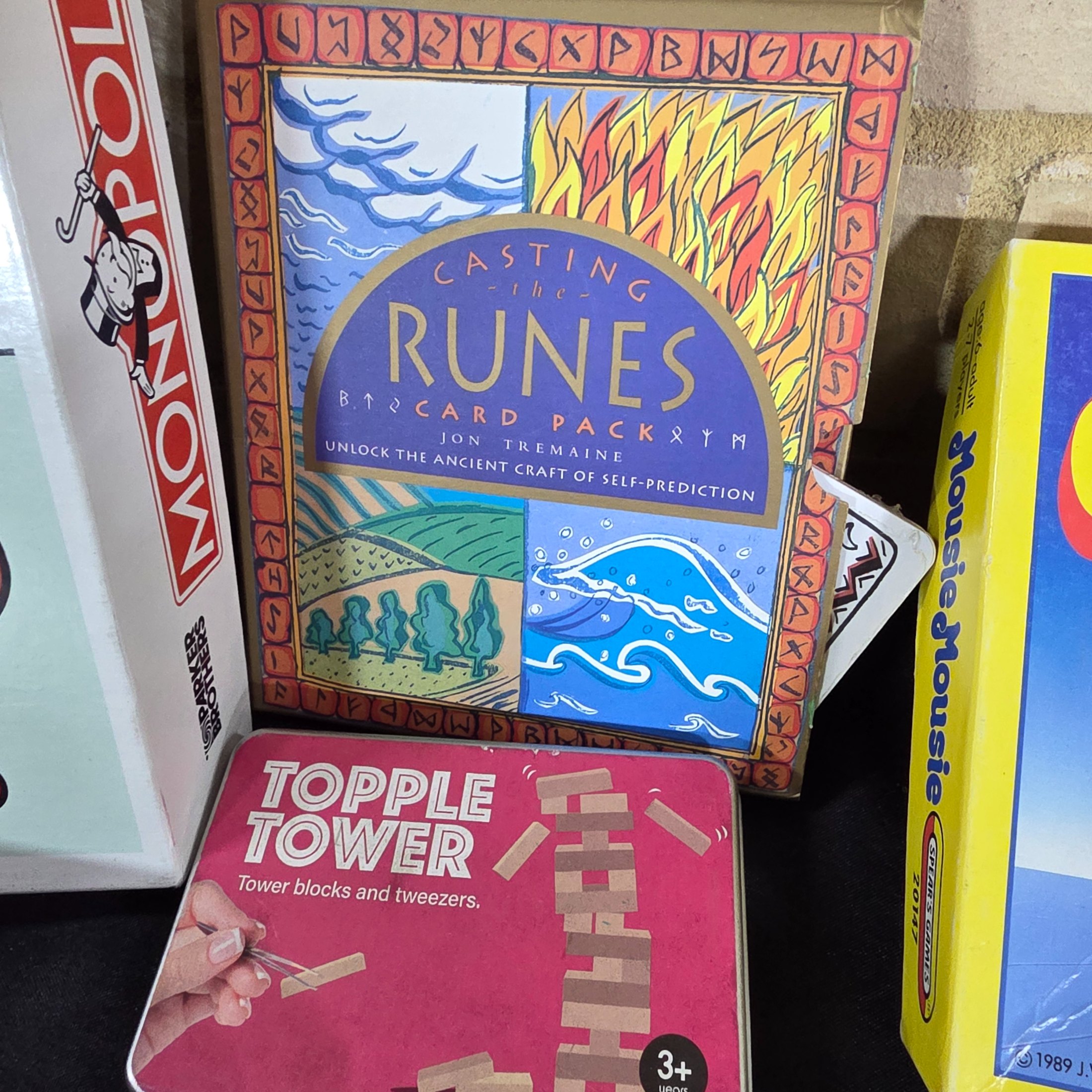 A diverse collection of modern and vintage board games, card games, and puzzles, including Monopoly, Jenga Quake, Mousie Mousie, and a Captain Cook's Voyage puzzle. - View 4
