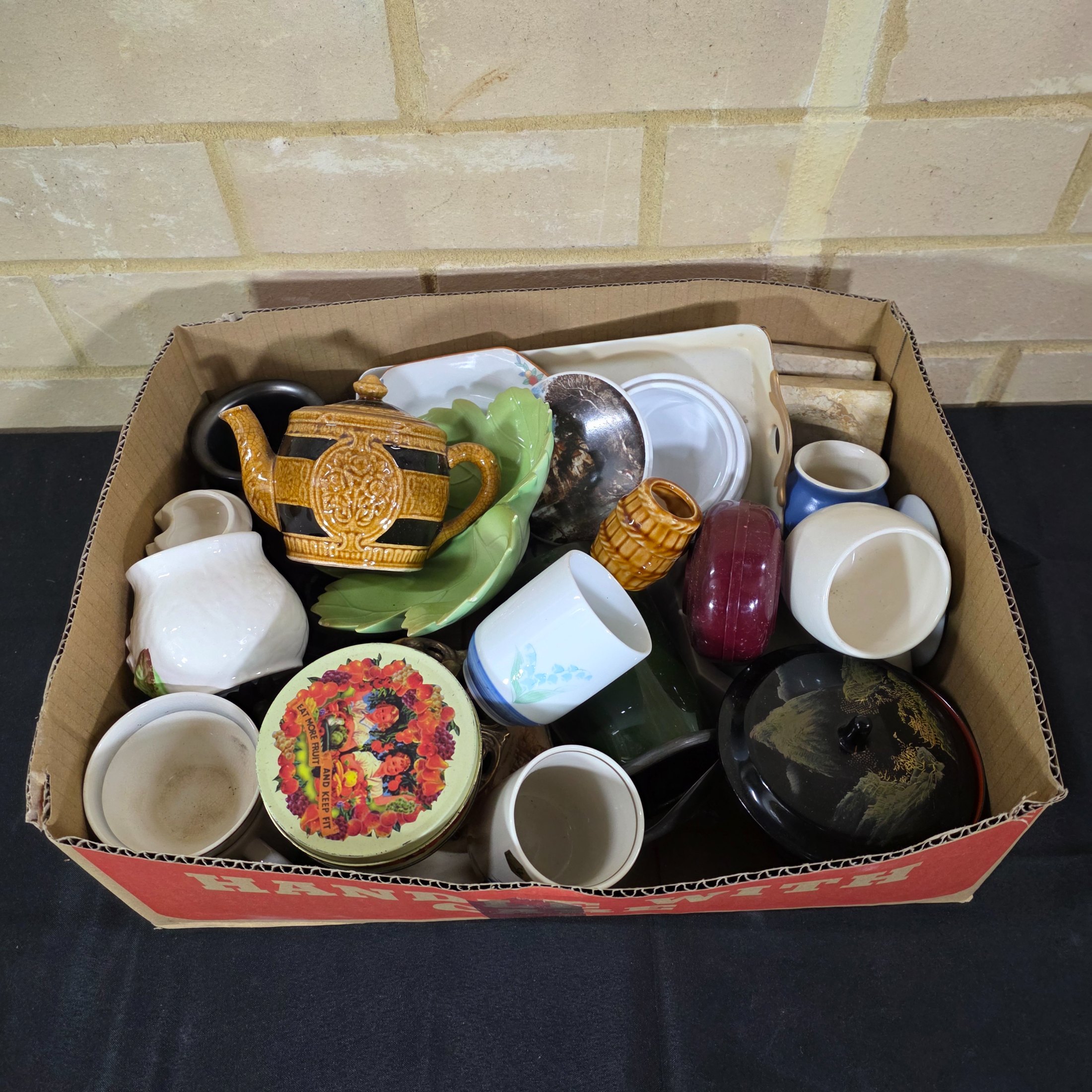 A diverse collection of vintage and antique homewares and decorative items, encompassing ceramics, metalware, glass, and wooden objects, presented as a mixed lot.