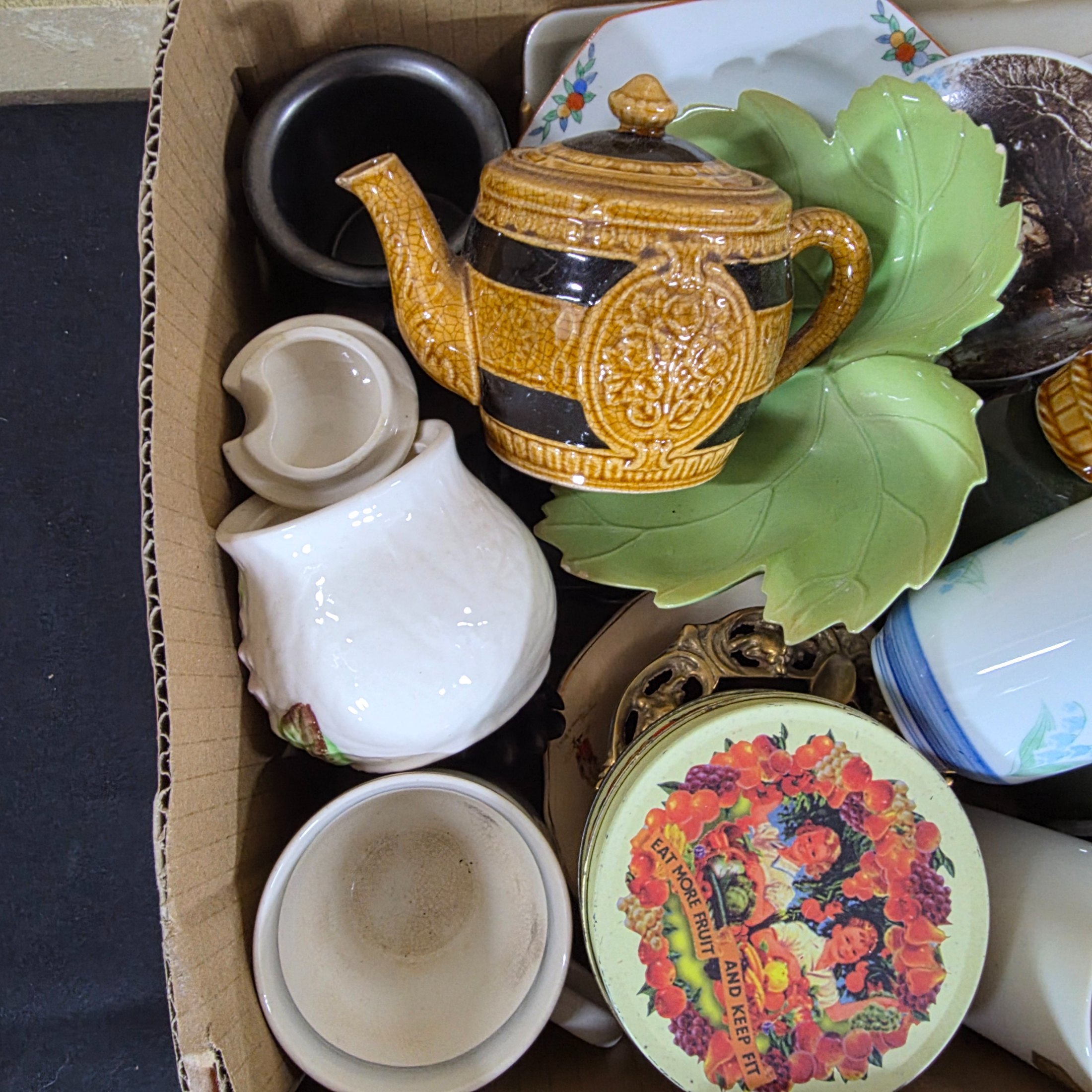 A diverse collection of vintage and antique homewares and decorative items, encompassing ceramics, metalware, glass, and wooden objects, presented as a mixed lot. - View 4