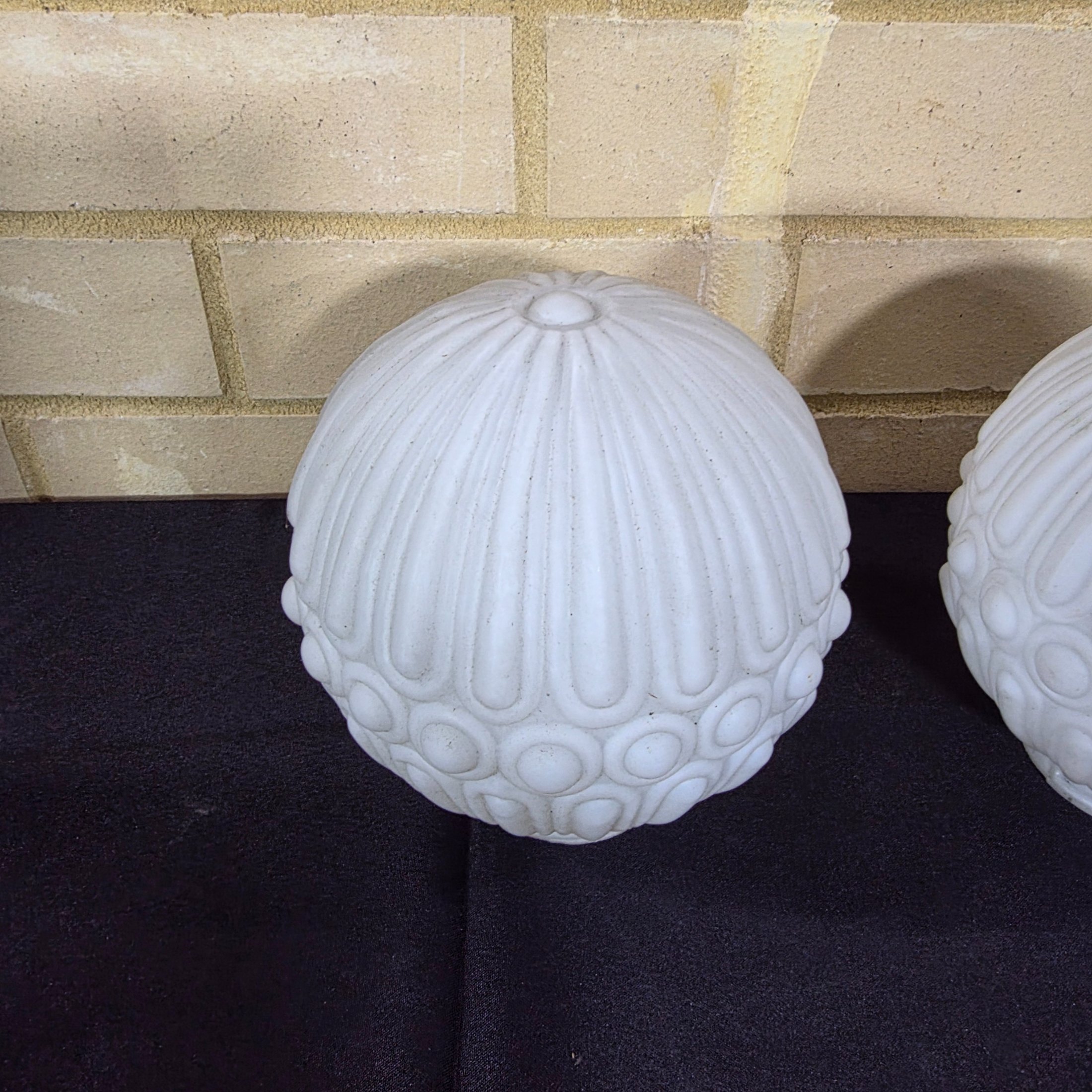 A pair of elegant mid-20th century frosted glass light shades, featuring a distinctive ribbed and raised circular motif, suitable for decorative lighting. - View 2