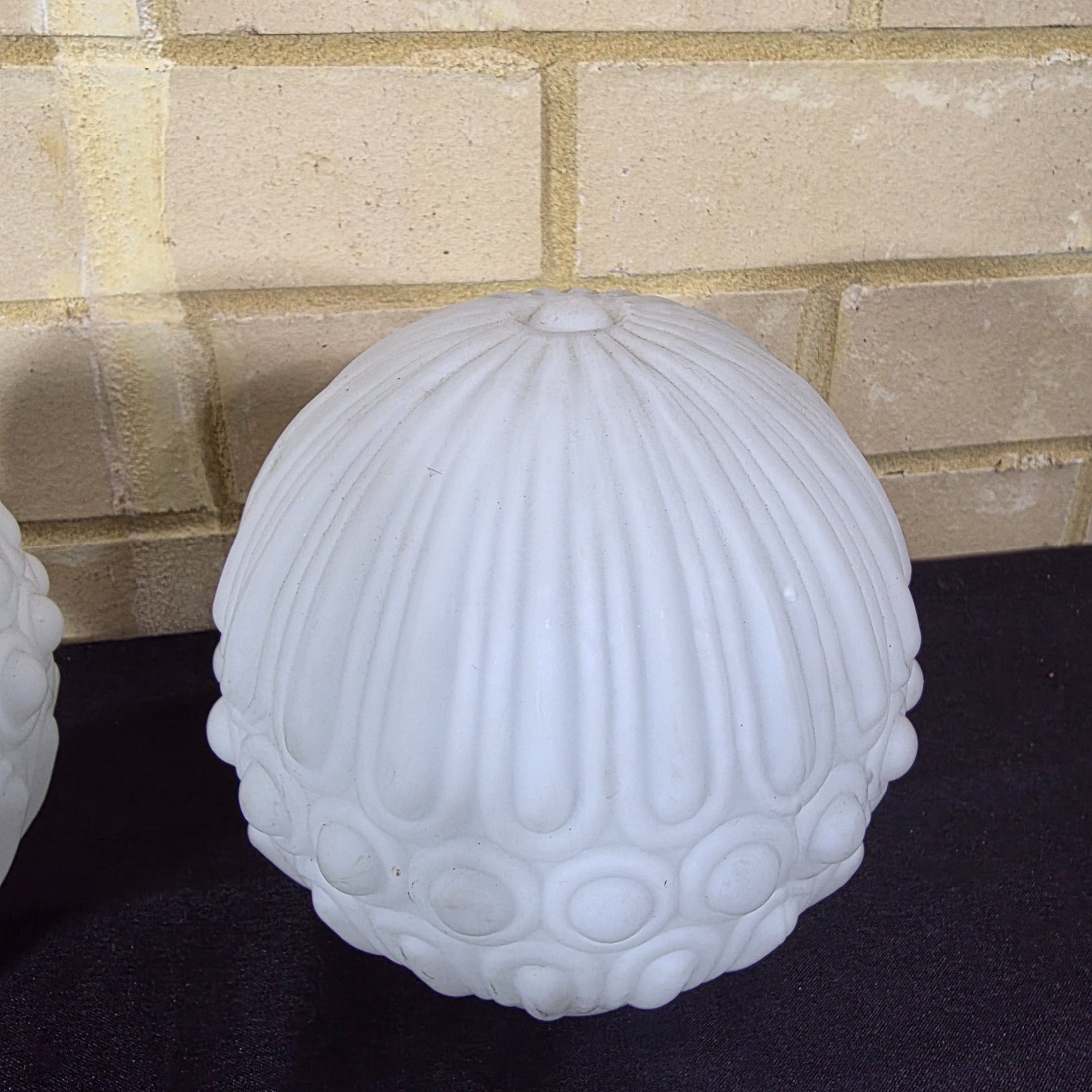A pair of elegant mid-20th century frosted glass light shades, featuring a distinctive ribbed and raised circular motif, suitable for decorative lighting. - View 3