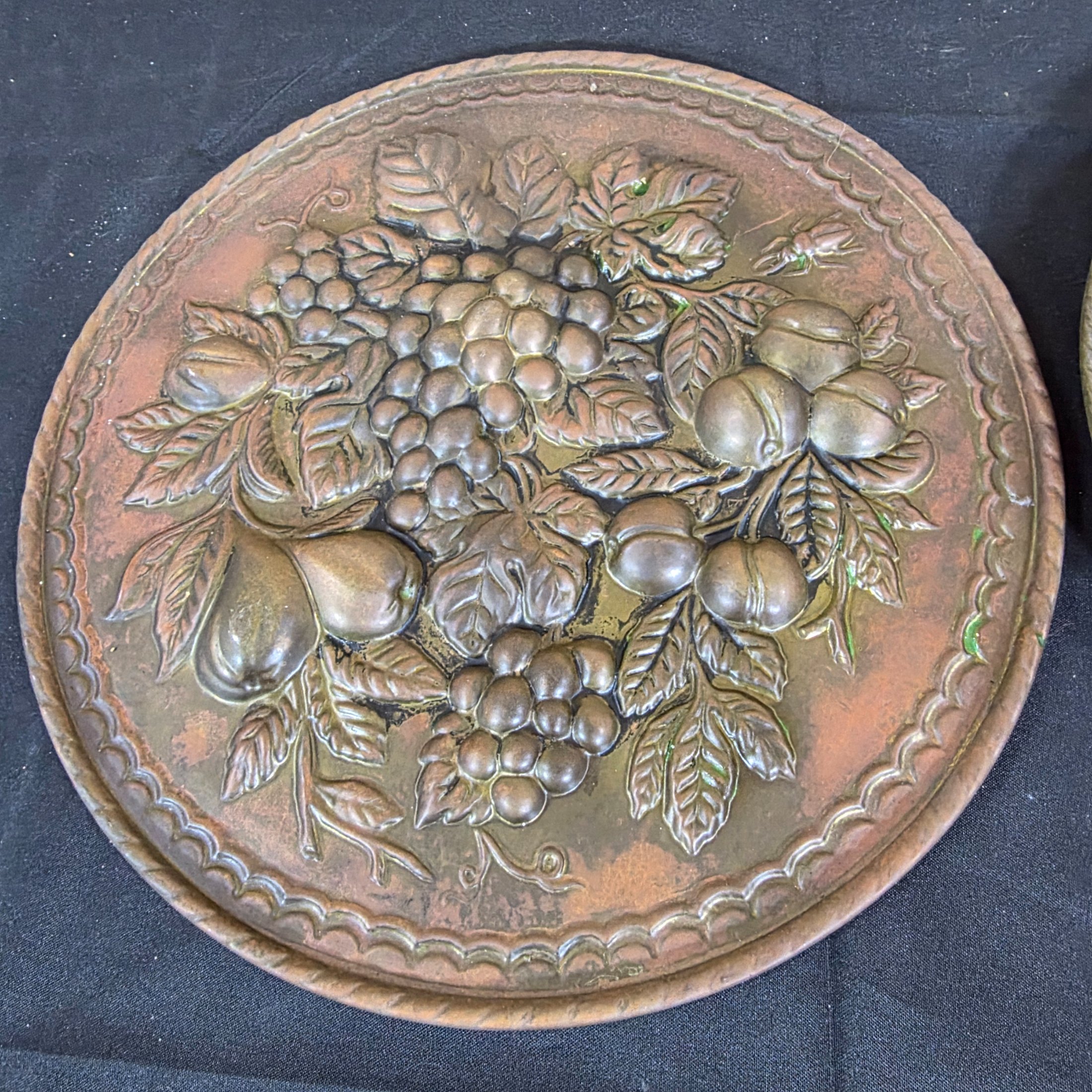 A set of three vintage decorative wall plaques, featuring embossed fruit designs in brass and copper-toned metal. - View 5