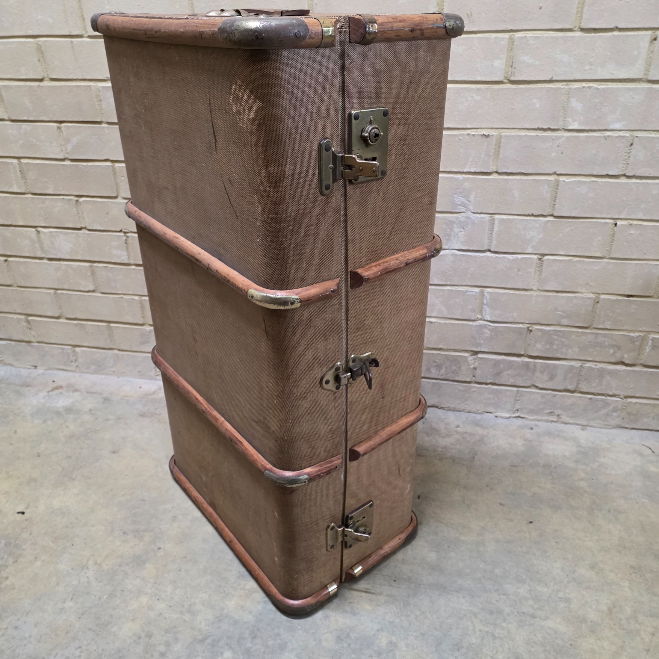 A classic vintage travel trunk from the early 20th century, made from woven fabric over a wooden frame with reinforcing wooden slats and metal hardware. - View 7