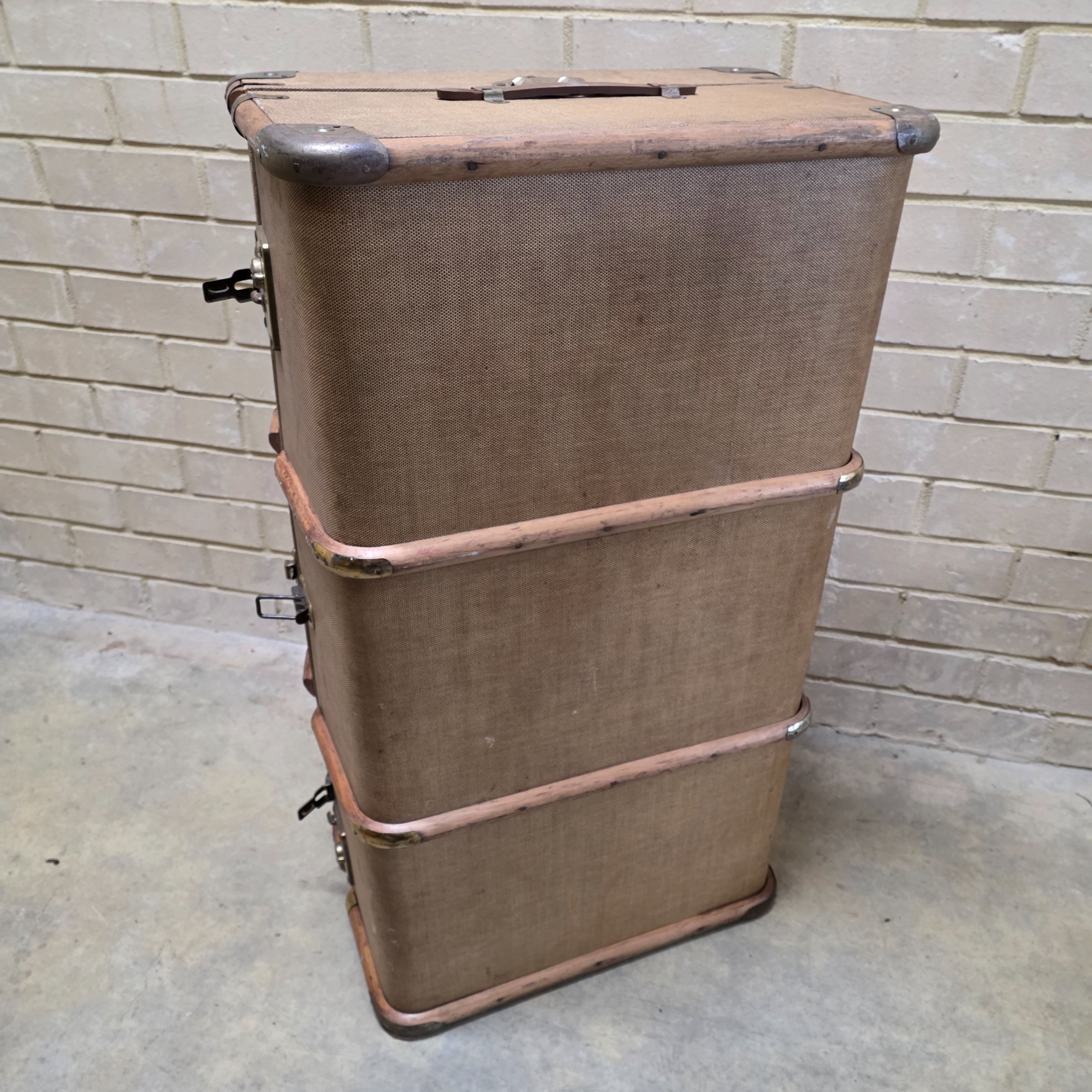 A classic vintage travel trunk from the early 20th century, made from woven fabric over a wooden frame with reinforcing wooden slats and metal hardware. - View 8