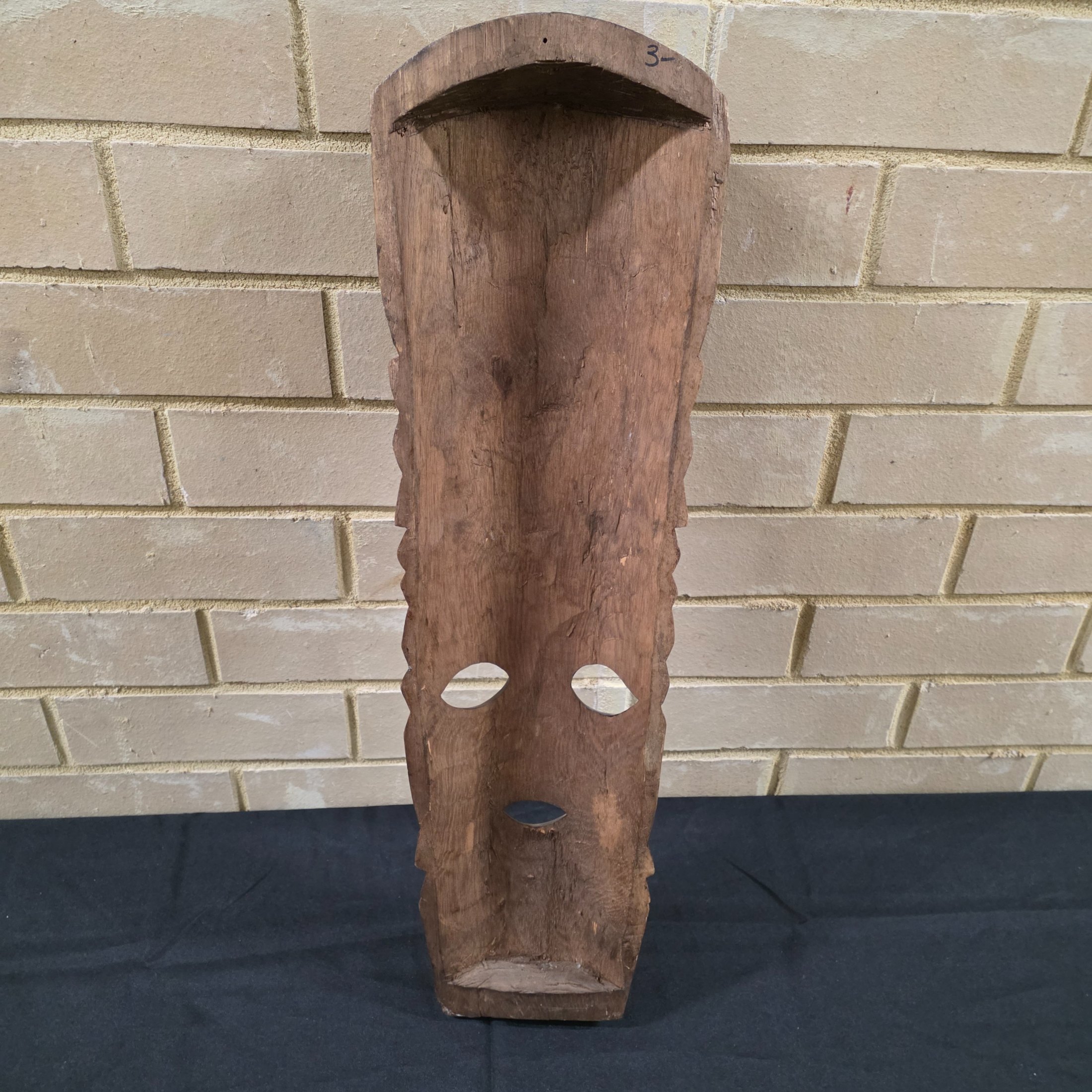 A striking vintage hand-carved wooden mask, featuring intricate tribal-style detailing and a rich dark wood finish, likely from the mid-20th century. - View 2