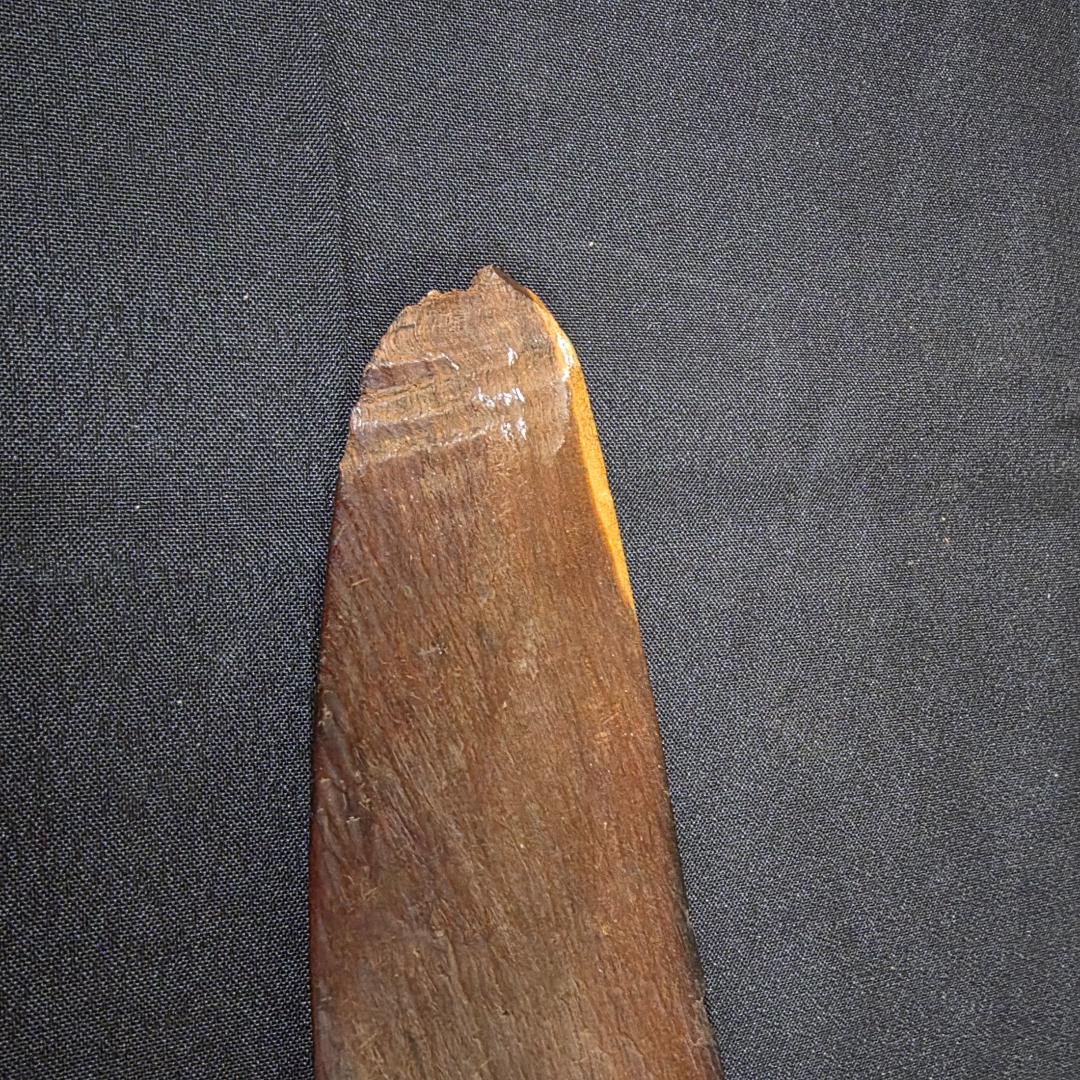 A vintage hand-carved wooden boomerang with a natural dark brown finish, approximately 62cm in length. - View 3