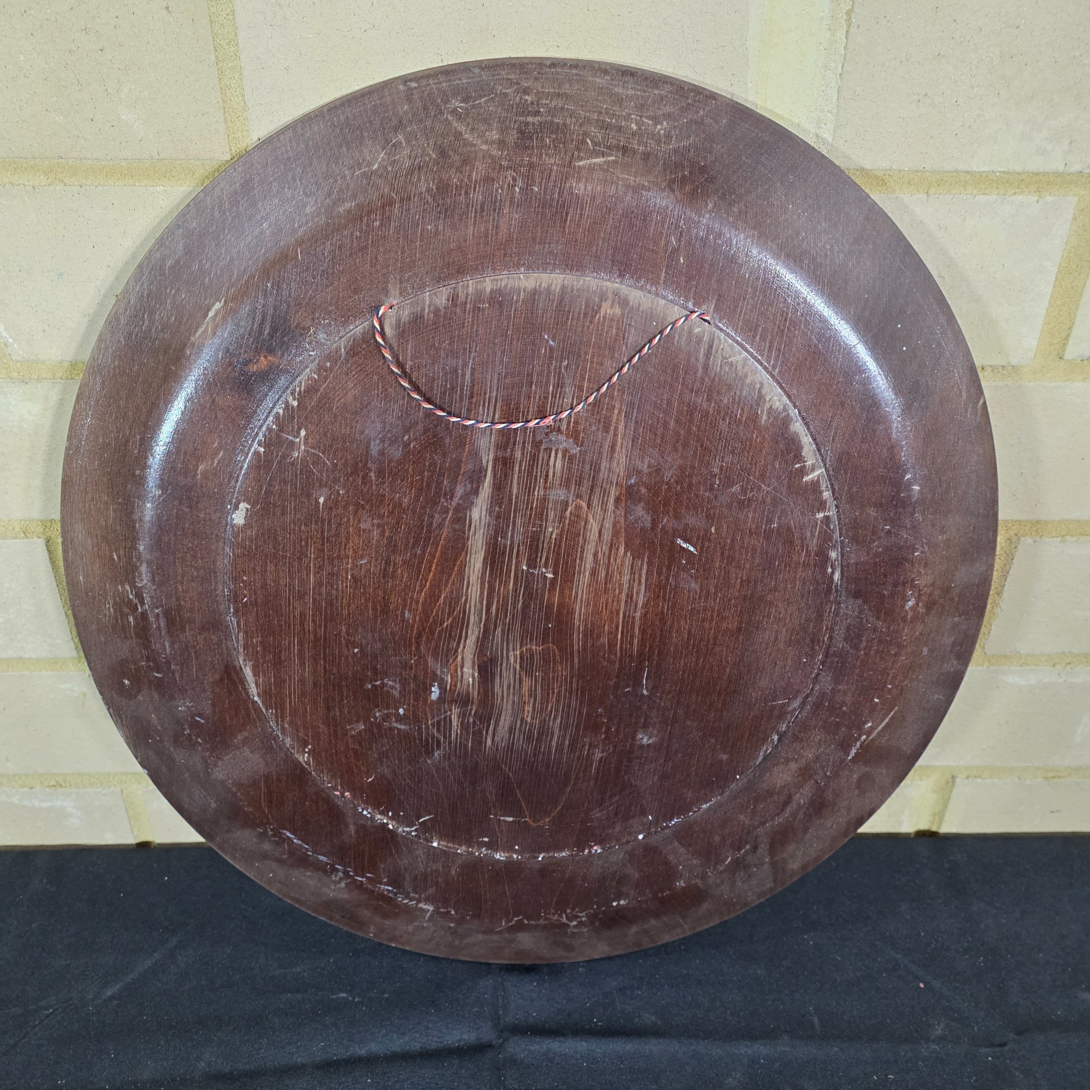 A vintage hand-carved wooden decorative plate, featuring intricate geometric and radial chip-carved patterns revealing lighter wood beneath a dark stain, likely mid-20th century. - View 4