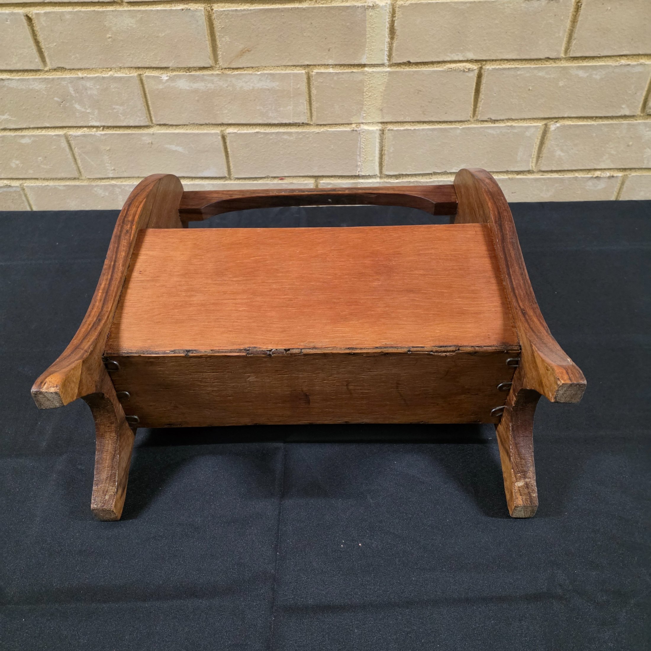 A classic vintage mid-century wooden magazine rack, featuring a curved handle and two functional compartments for storage. This piece showcases the simple, elegant design characteristic of its era, crafted from solid wood with a warm, natural finish. - View 4