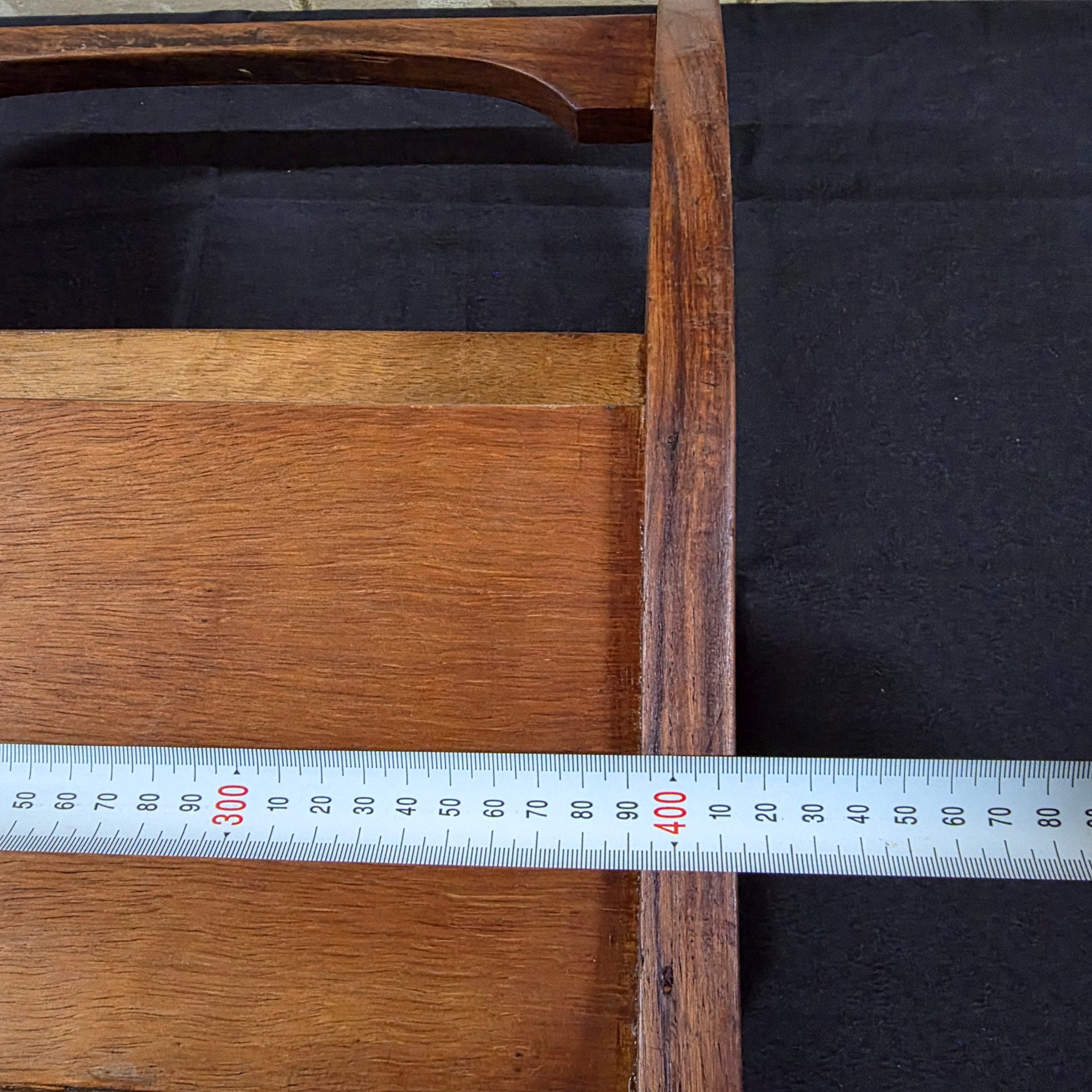 A classic vintage mid-century wooden magazine rack, featuring a curved handle and two functional compartments for storage. This piece showcases the simple, elegant design characteristic of its era, crafted from solid wood with a warm, natural finish. - View 5