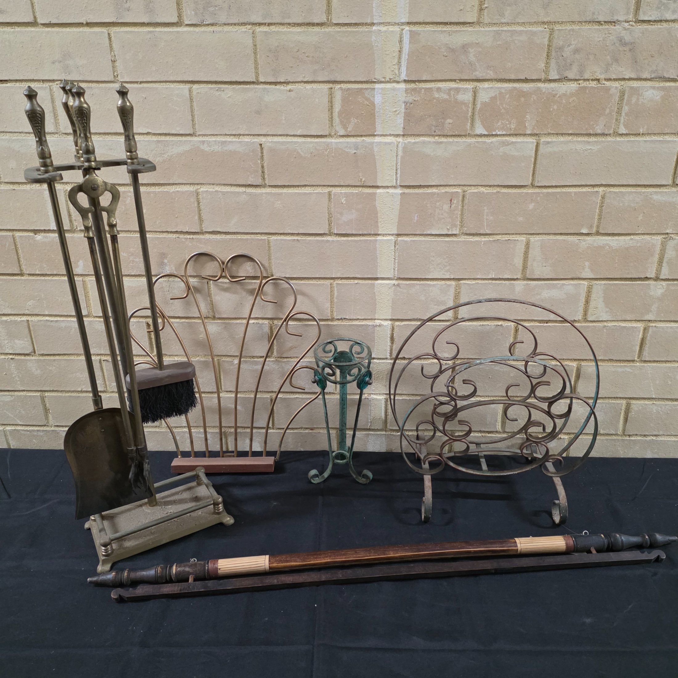 A comprehensive lot of vintage homewares and fireplace accessories, showcasing a blend of metallic craftsmanship and rustic charm, dating from the mid-20th century.