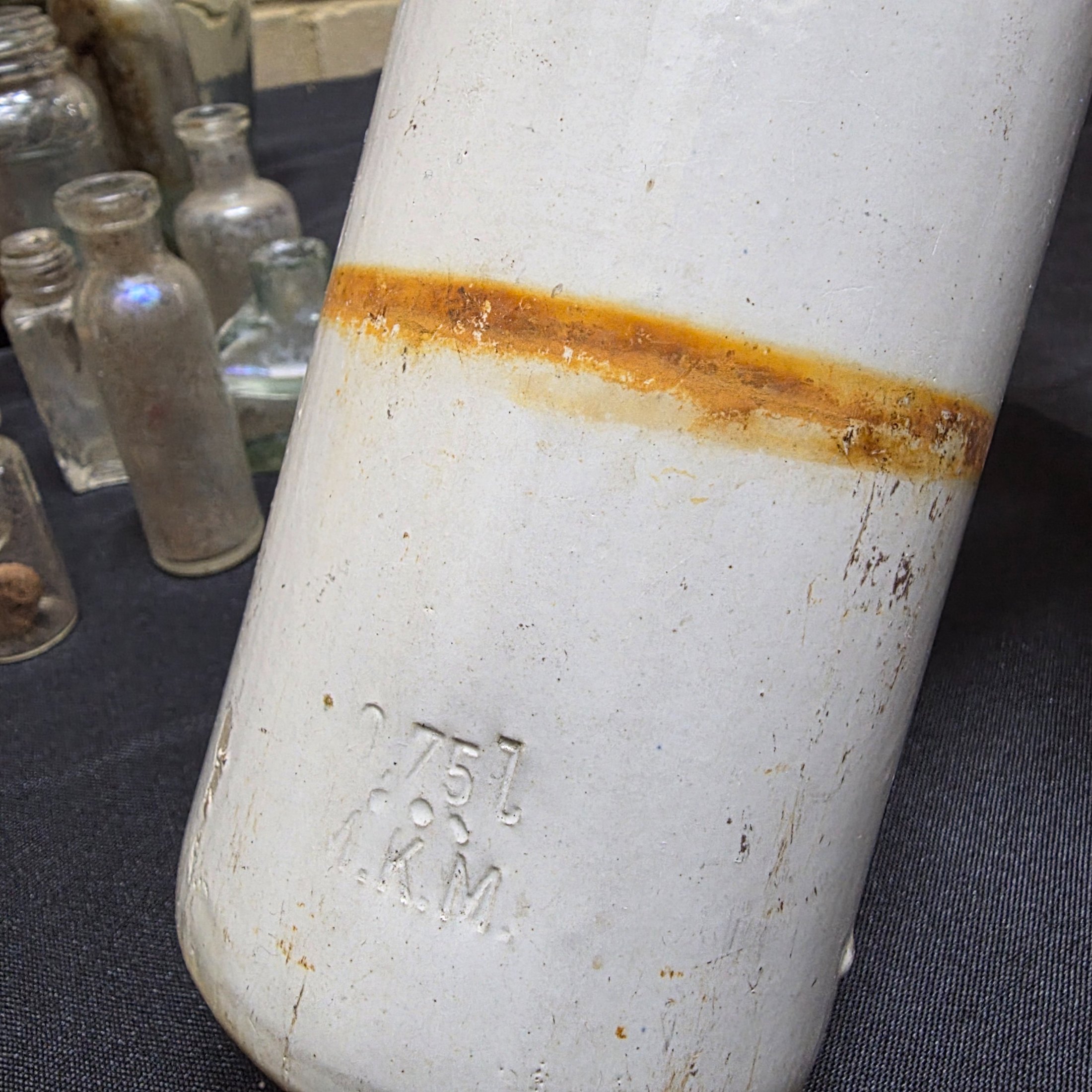 A diverse collection of antique and vintage glass and ceramic bottles and jars, dating from the late 19th to mid-20th century, showcasing various styles and materials. - View 2
