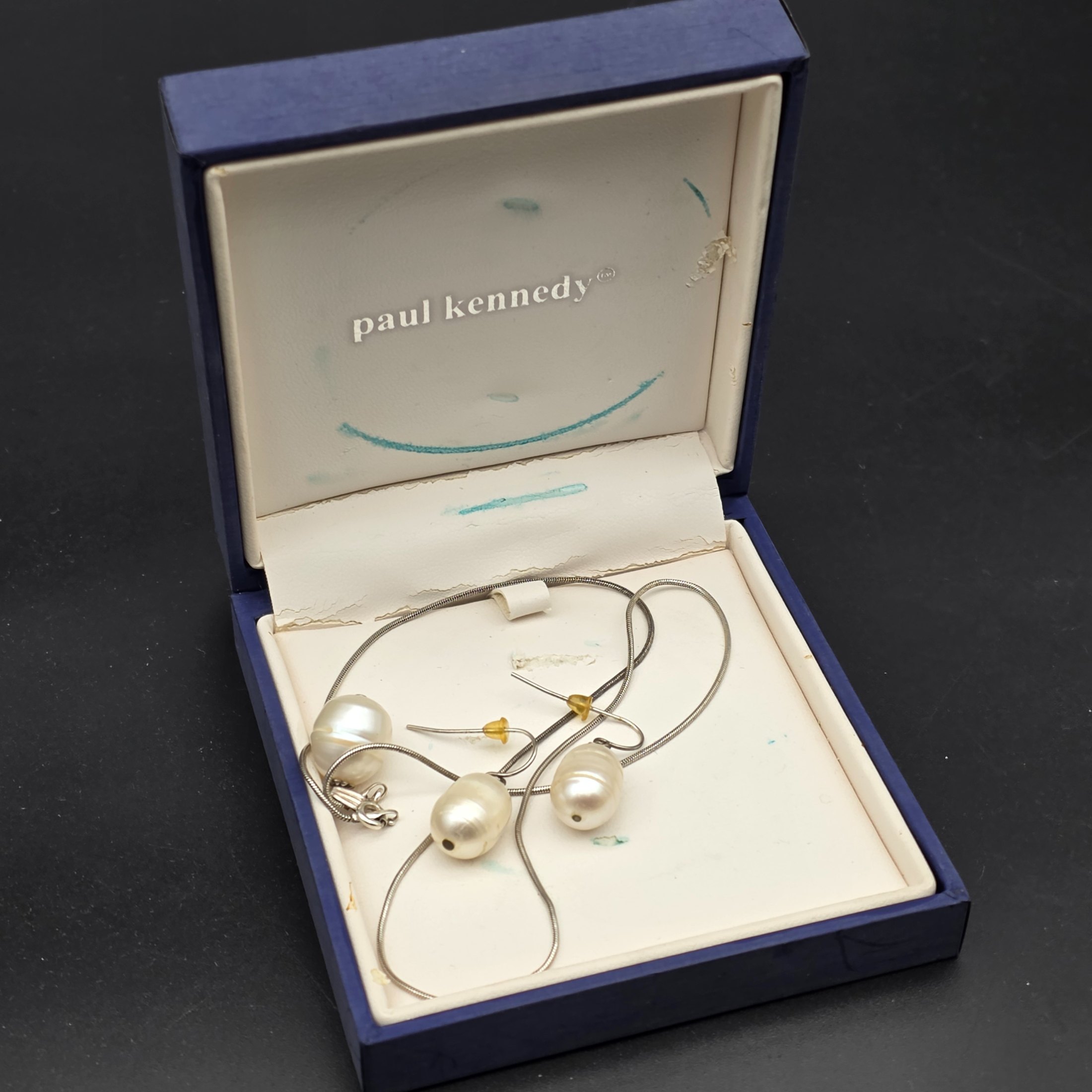 A matching Paul Kennedy sterling silver and baroque freshwater pearl necklace and earring set. This contemporary jewellery suite features a snake chain necklace with a single irregular pearl pendant and a pair of coordinating hook earrings, each set with a baroque pearl. - View 8