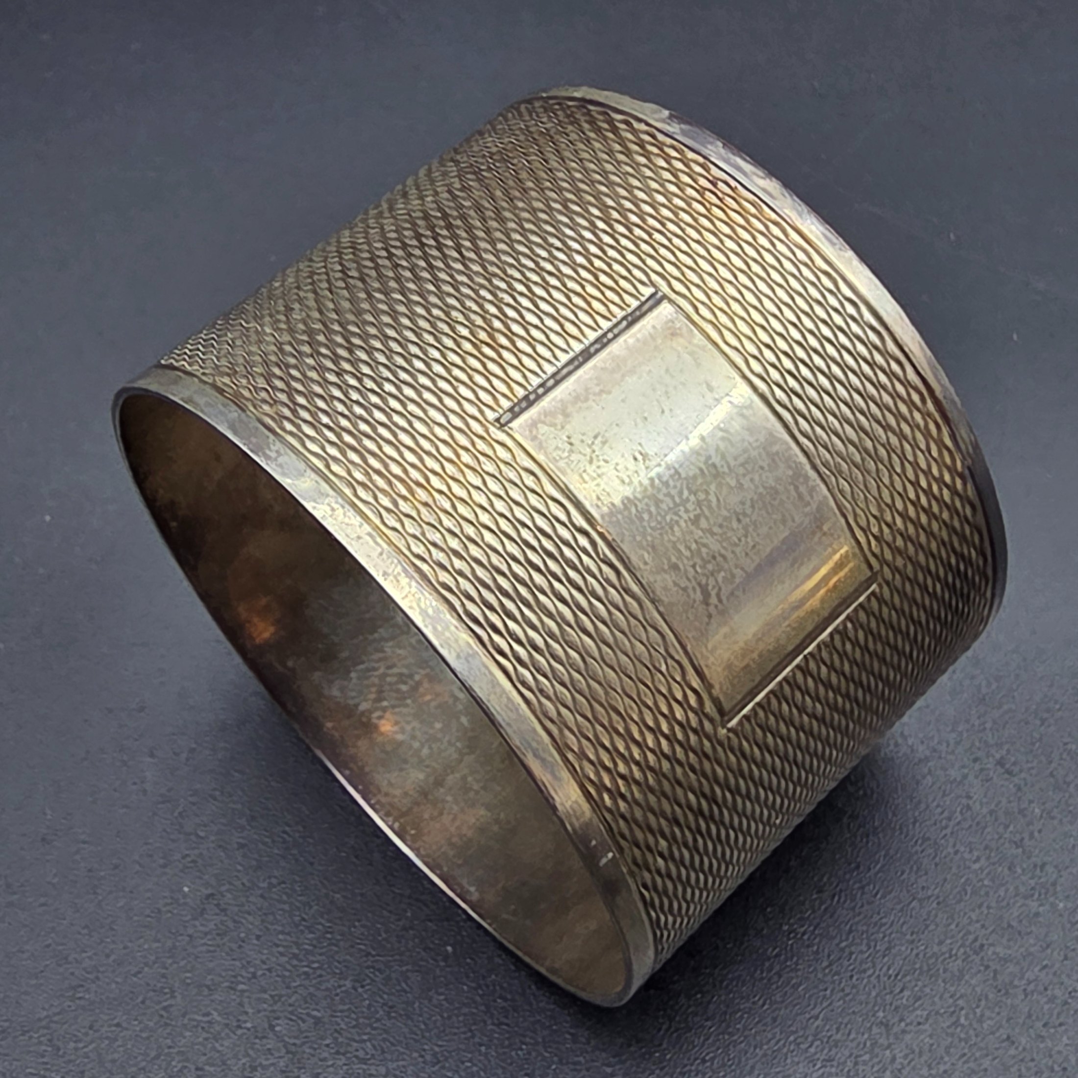 A collection of four vintage silver-toned items, including a sterling silver napkin ring, a second napkin ring, a ribbed cup, and a lidded box, dating from the early to mid-20th century. - View 3