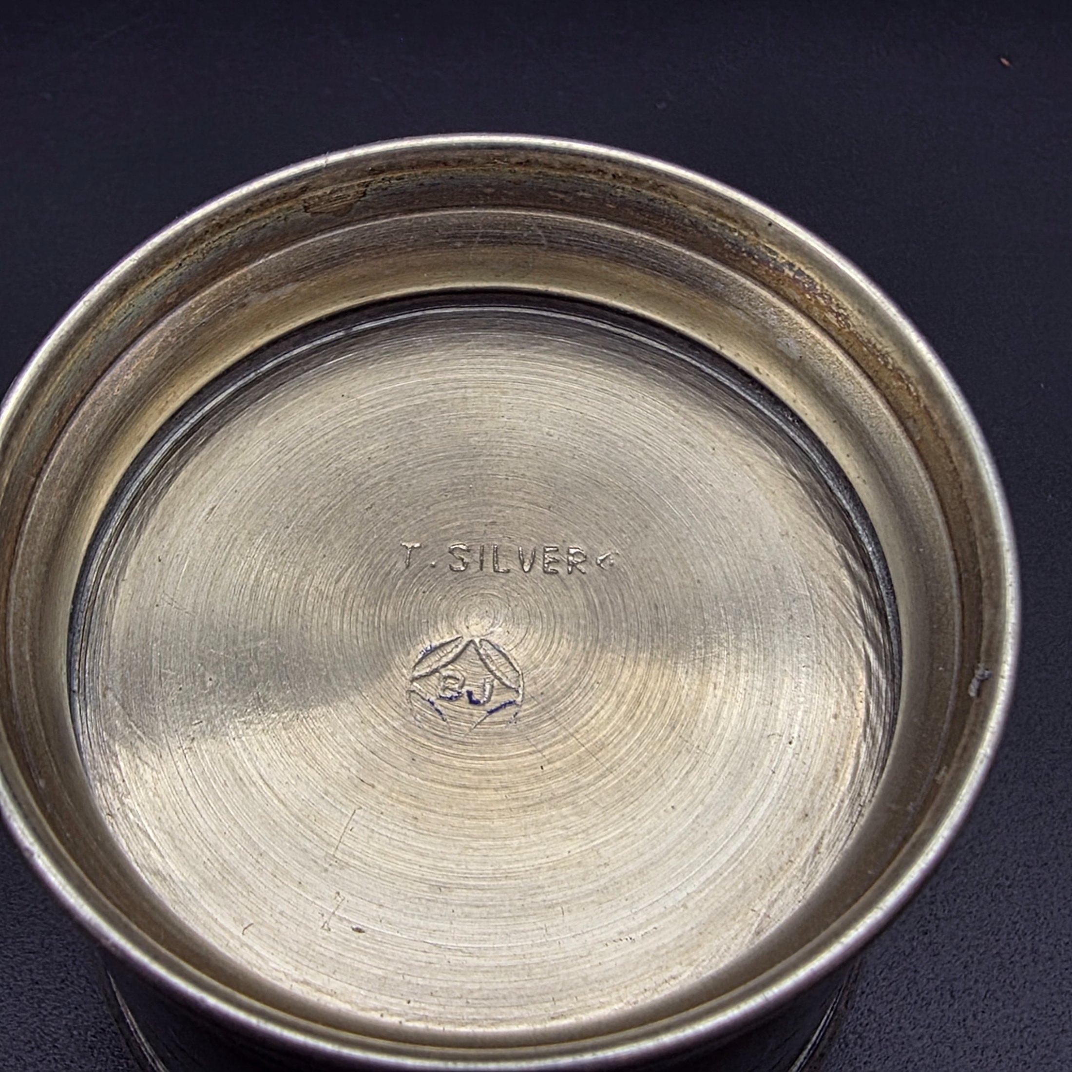 A collection of four vintage silver-toned items, including a sterling silver napkin ring, a second napkin ring, a ribbed cup, and a lidded box, dating from the early to mid-20th century. - View 6