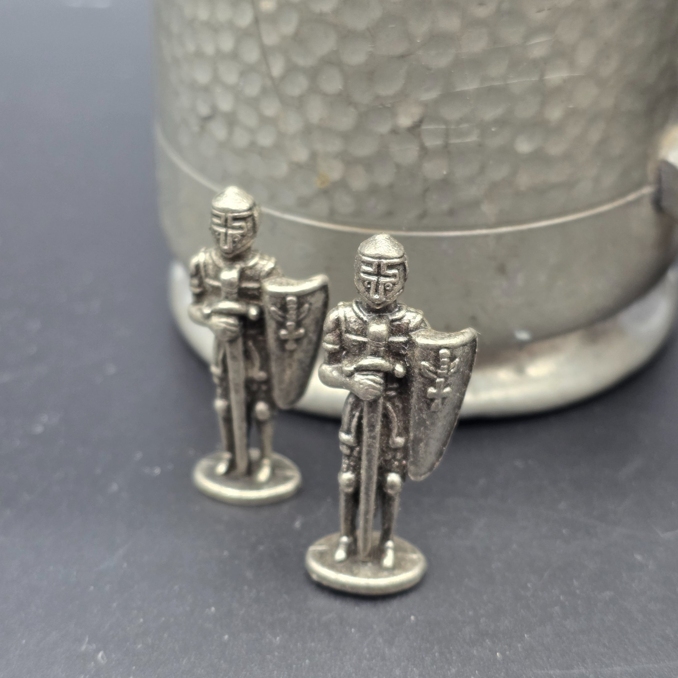 A collection featuring three vintage pewter tankards and two small pewter knight figurines, showcasing different manufacturing origins and finishes from the mid to late 20th century. - View 2