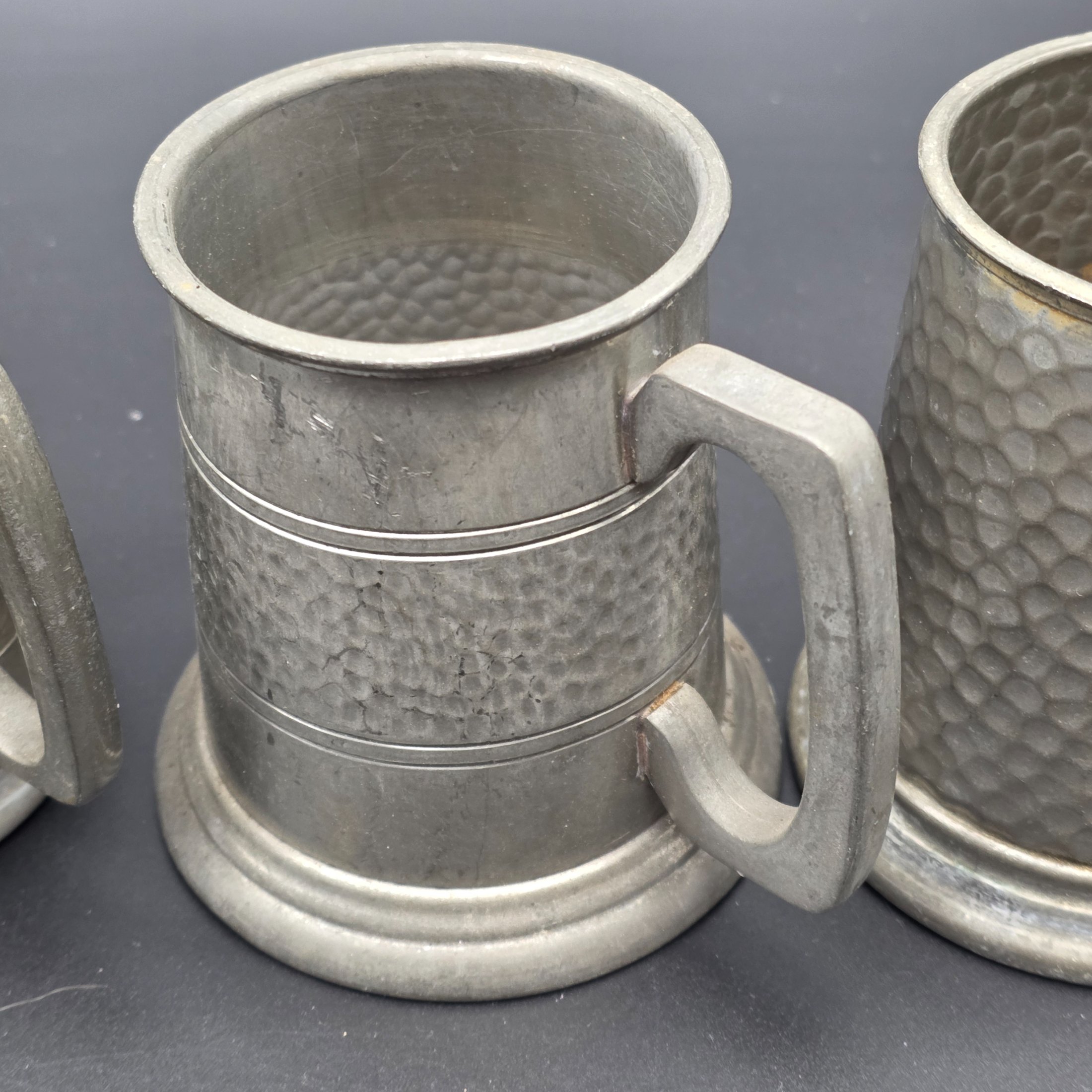 A collection featuring three vintage pewter tankards and two small pewter knight figurines, showcasing different manufacturing origins and finishes from the mid to late 20th century. - View 4