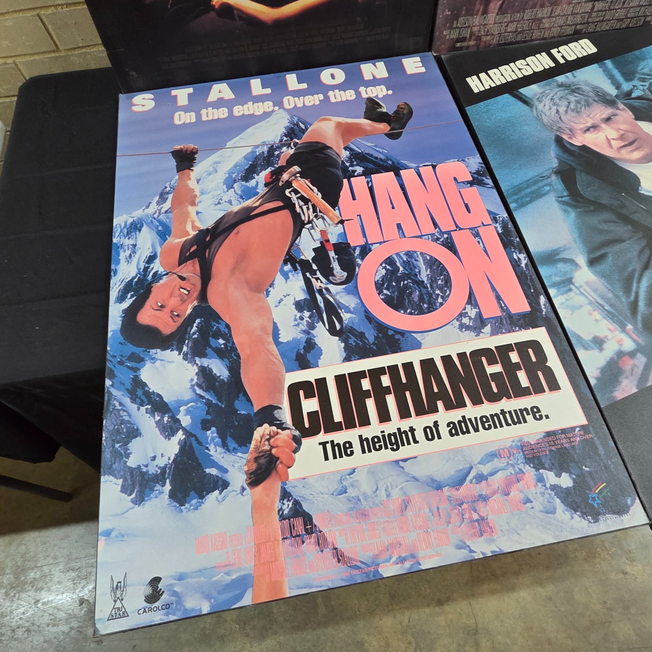 Four mounted original movie posters from the early 1990s, featuring classic action films 'Rising Sun', 'Nowhere to Run', 'Cliffhanger', and 'The Fugitive'. - View 5