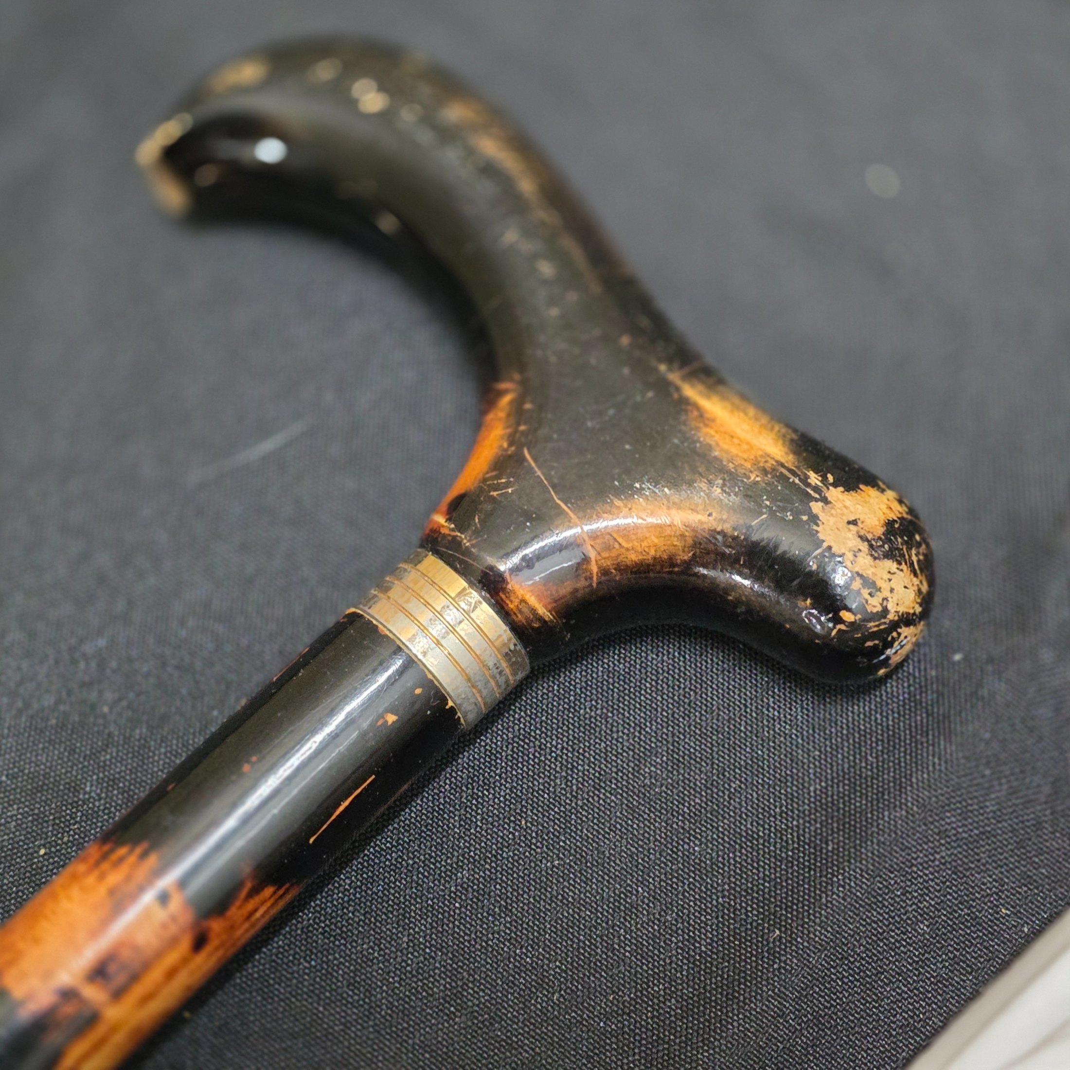 A collection of two vintage walking sticks and a white Sunbella umbrella, including one walking stick with a hallmarked sterling silver cap. - View 6