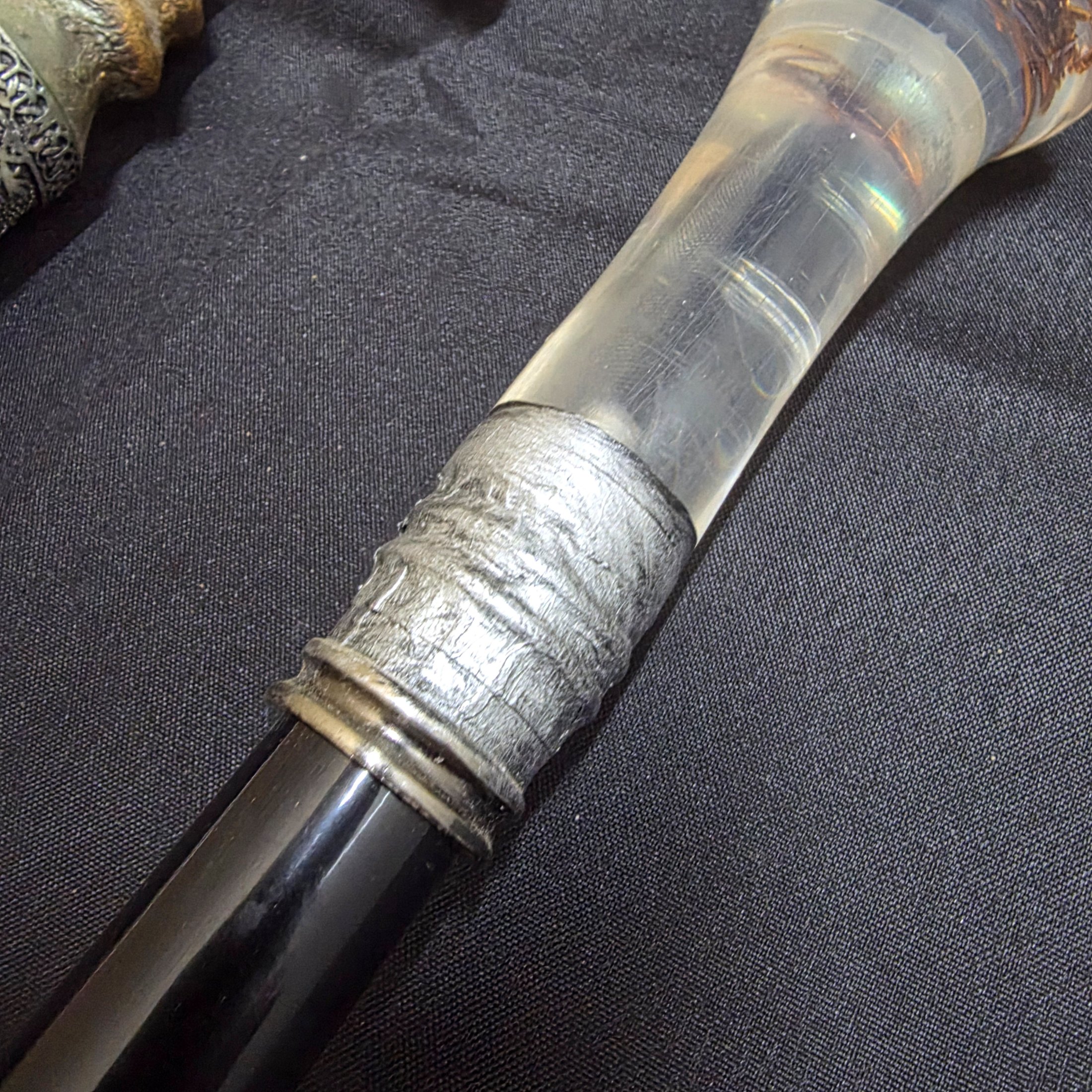 A collection of three vintage decorative walking sticks, featuring a carved wooden handle, a dragon-head handle, and a clear resin handle with an embedded scorpion. - View 4