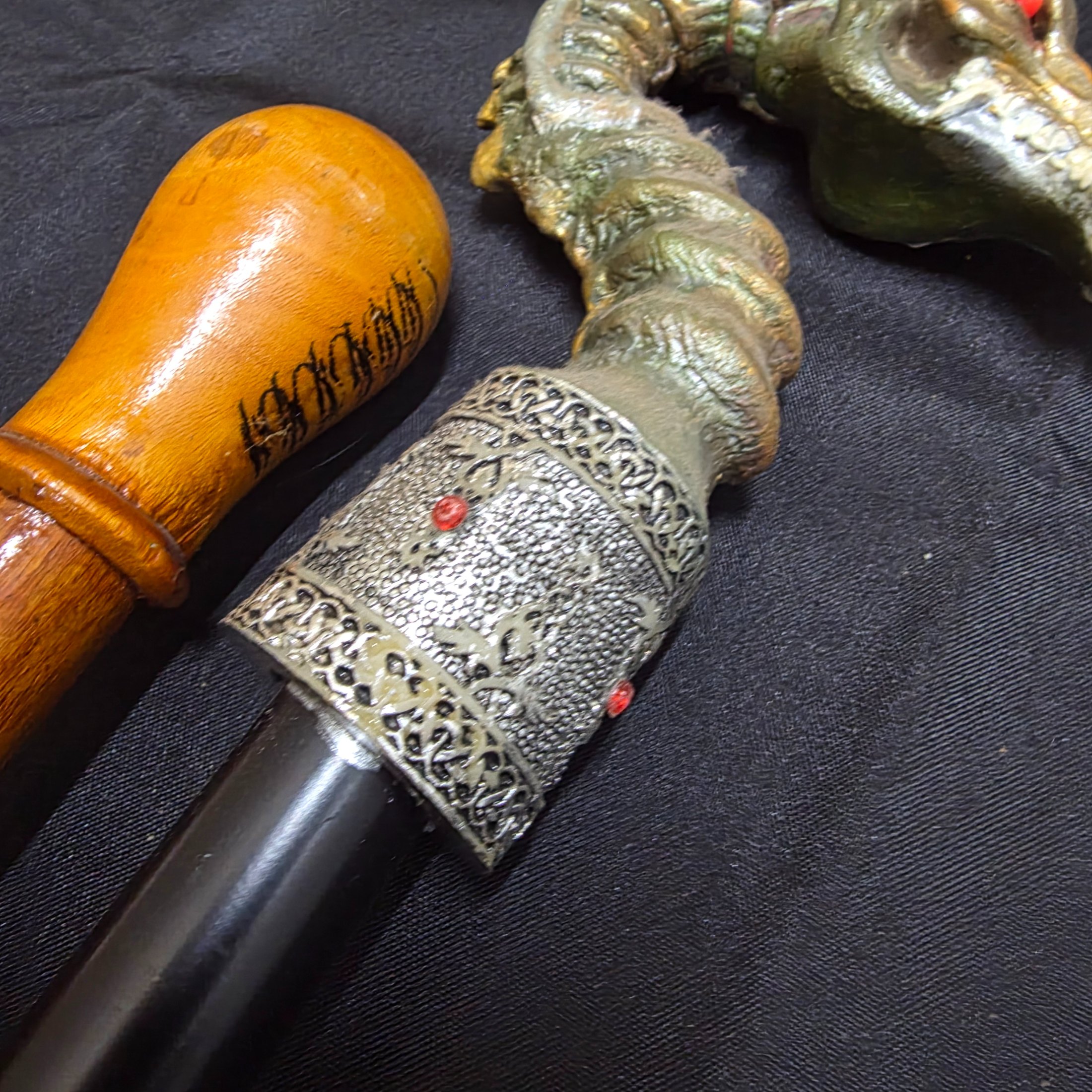 A collection of three vintage decorative walking sticks, featuring a carved wooden handle, a dragon-head handle, and a clear resin handle with an embedded scorpion. - View 6