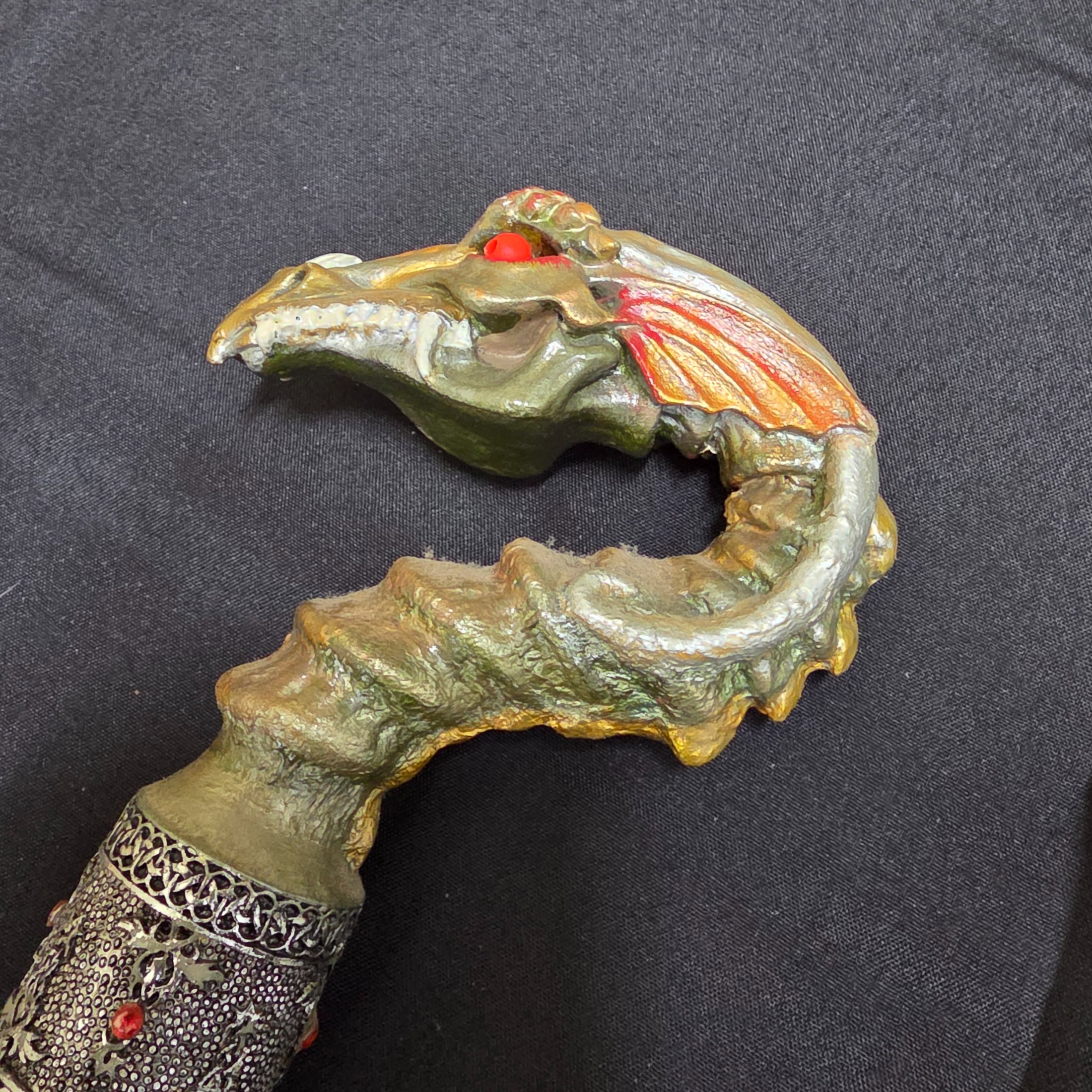 A collection of three vintage decorative walking sticks, featuring a carved wooden handle, a dragon-head handle, and a clear resin handle with an embedded scorpion. - View 8