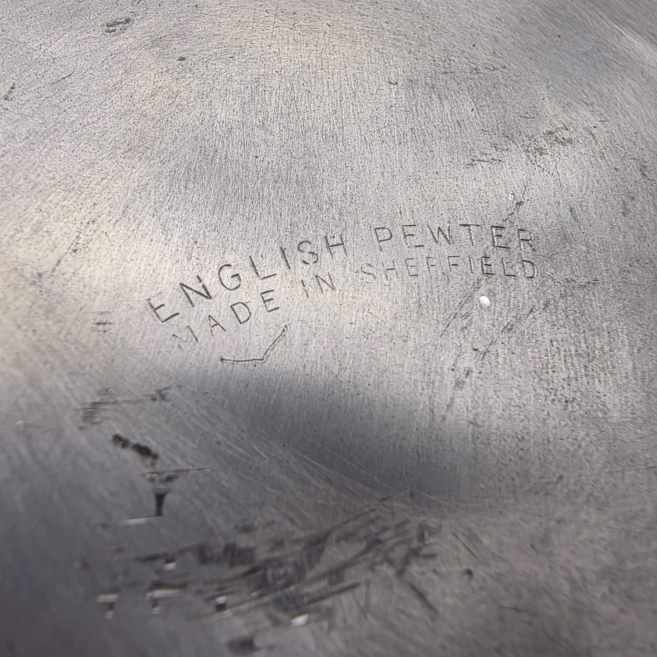 A collection of three traditional English pewter vessels, including a tankard with a unique nude figure handle, and two pitchers. These pieces originate from Sheffield, a city historically renowned for its metalwork and pewter manufacturing. - View 8