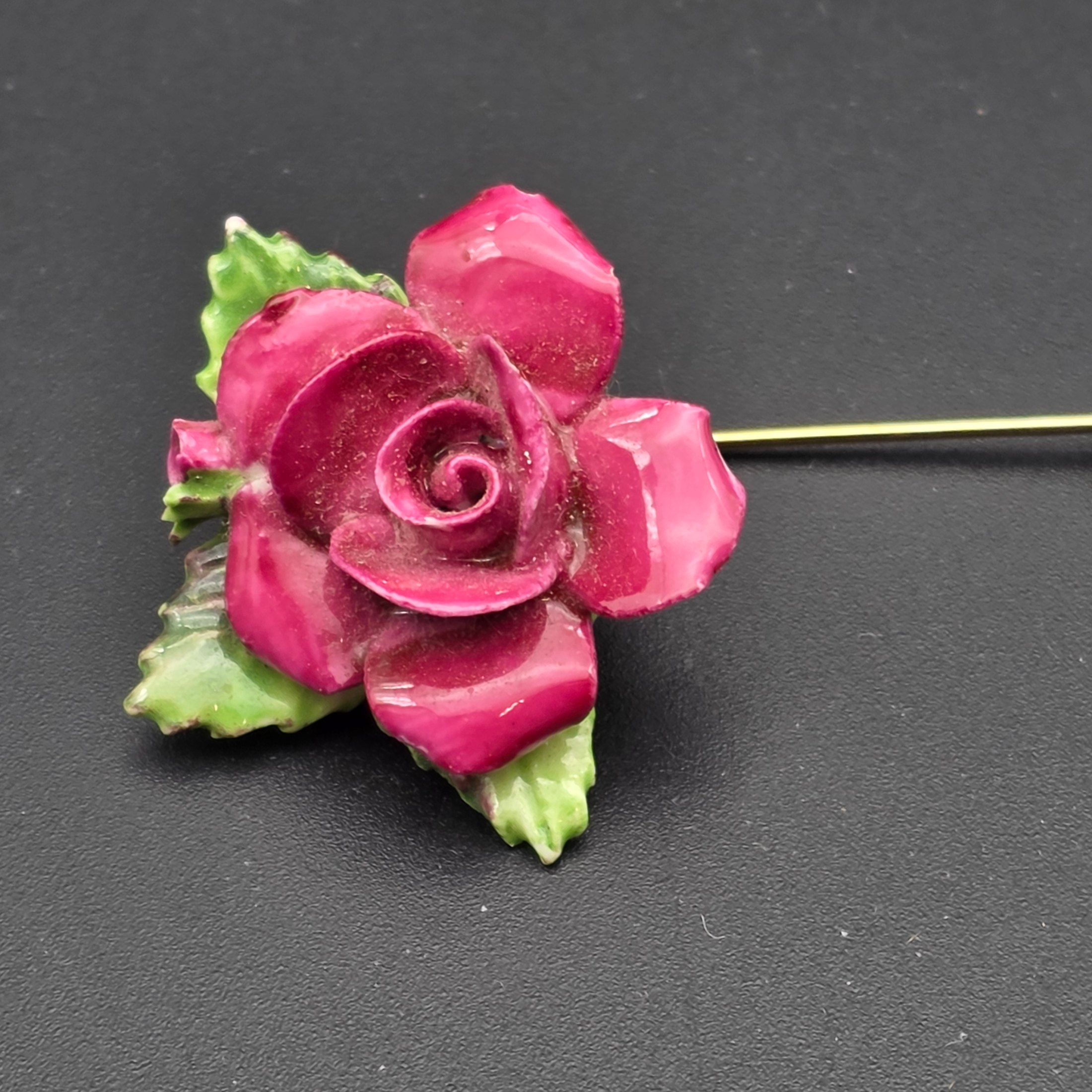 A collection of vintage personal accessories including a bee stick pin, a peacock brooch, a ceramic rose hat pin, and a cased magnifying glass in a red box. - View 8