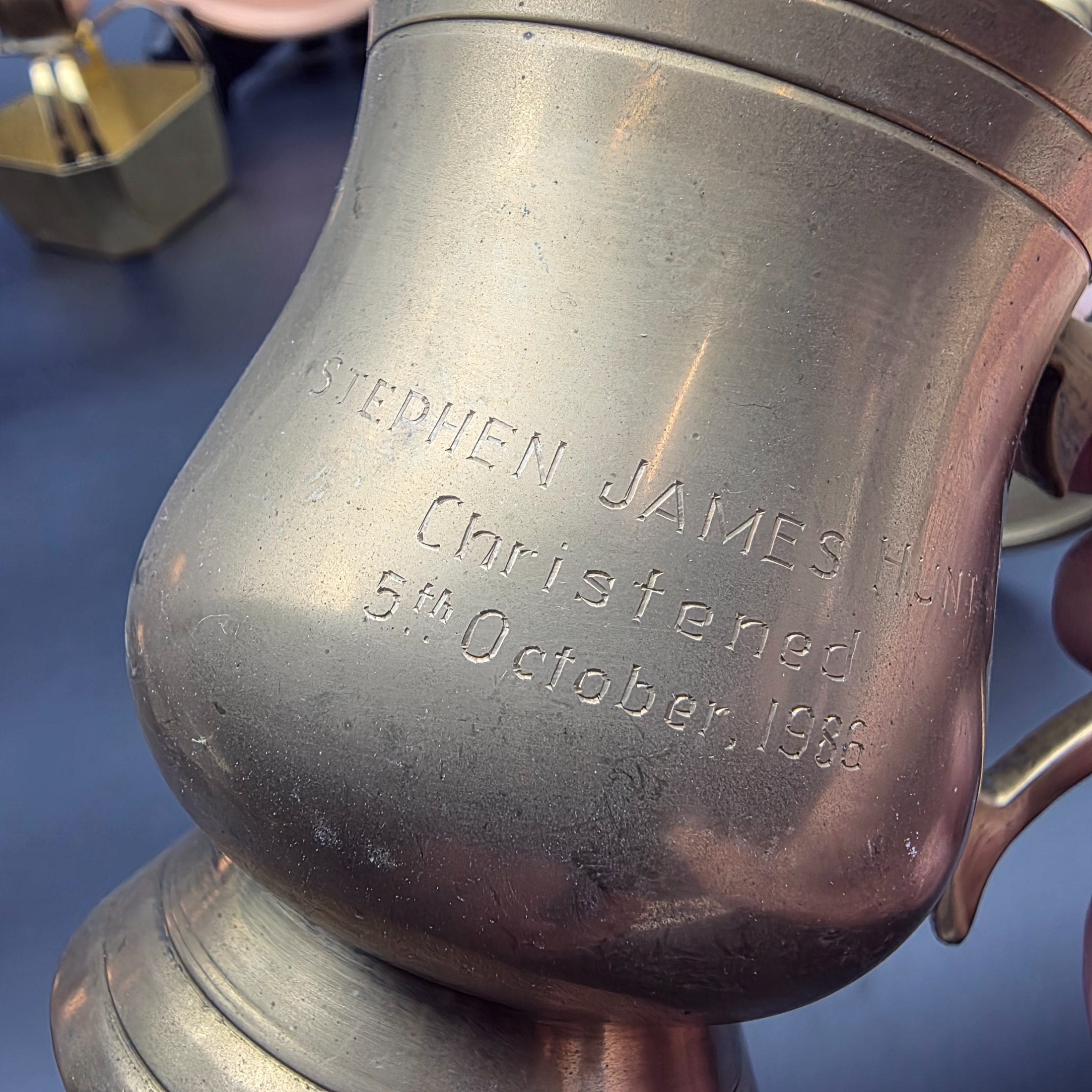A collection of various vintage brass and copper sundries, including candlesticks, a decorative tray, a mug, an ashtray, and a small basket. - View 8