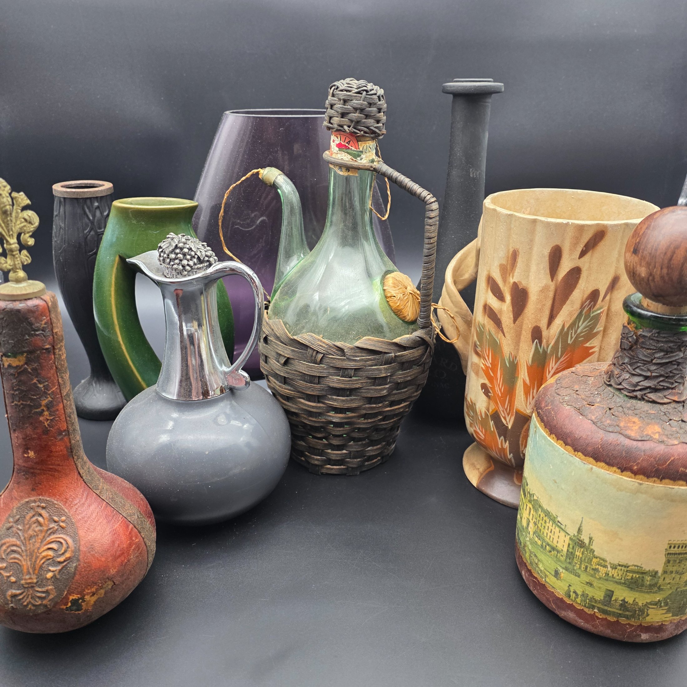 A mixed lot of vintage decorative items including wicker and leather-wrapped glass bottles, ceramic vases from Hamilton England, and an empty Otard XO Cognac bottle.