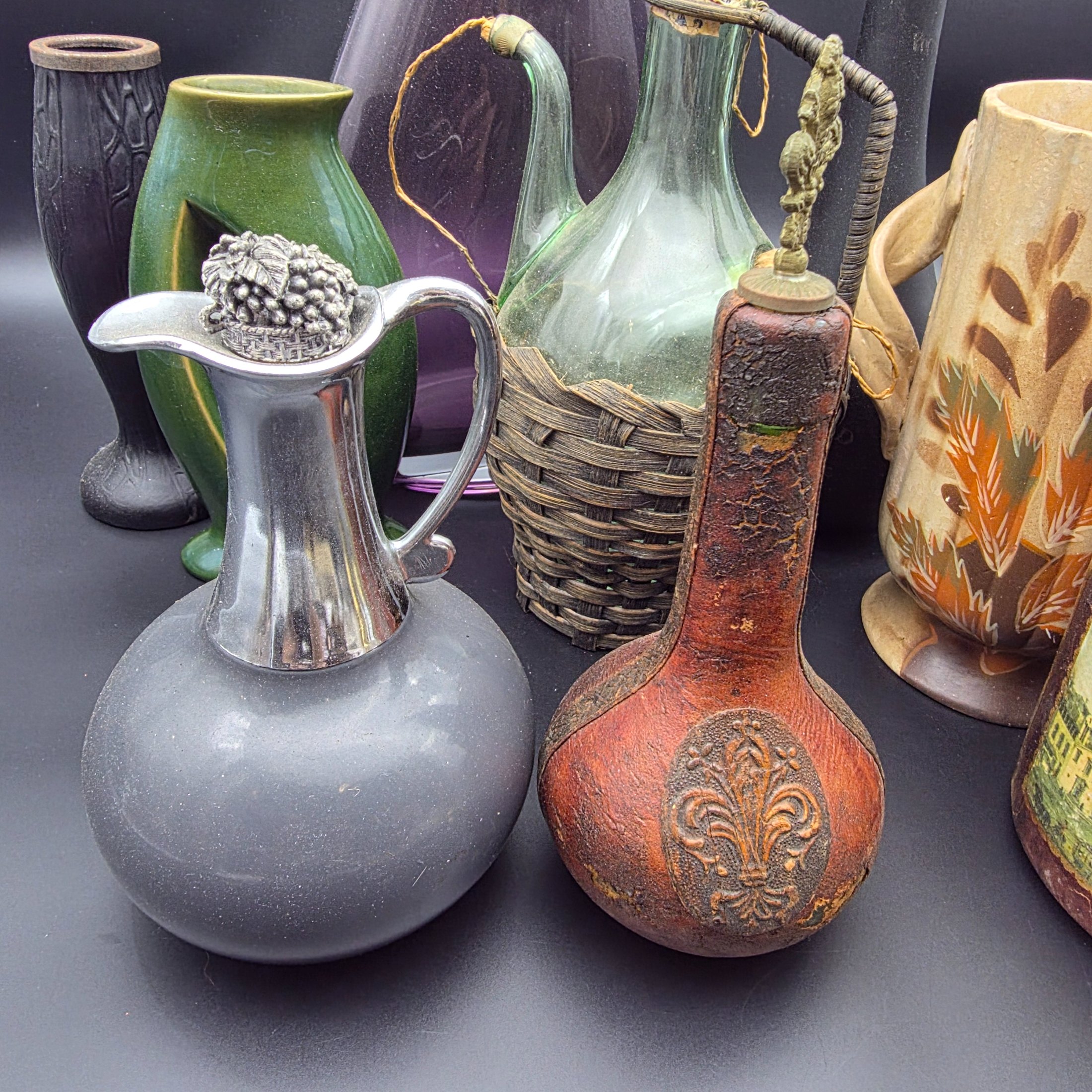 A mixed lot of vintage decorative items including wicker and leather-wrapped glass bottles, ceramic vases from Hamilton England, and an empty Otard XO Cognac bottle. - View 2