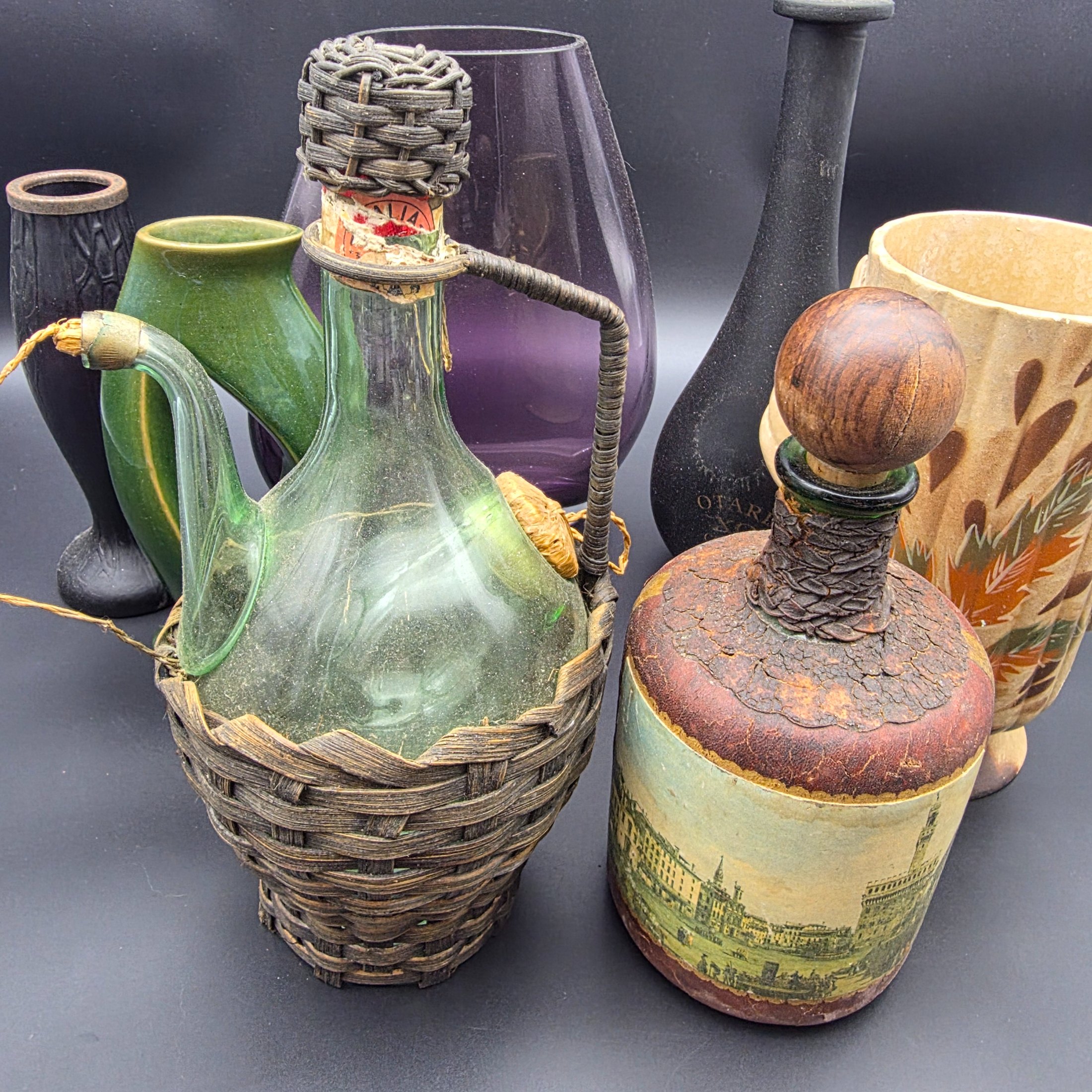 A mixed lot of vintage decorative items including wicker and leather-wrapped glass bottles, ceramic vases from Hamilton England, and an empty Otard XO Cognac bottle. - View 6