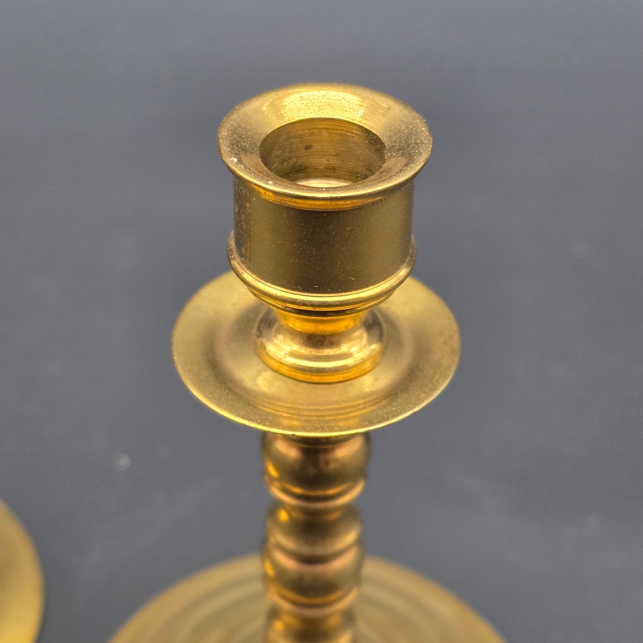 A pair of vintage brass candlesticks, stamped with "Soho Foundry Sovereign Hill Ballarat Australia" and featuring a mining derrick logo, showcasing traditional craftsmanship. - View 3