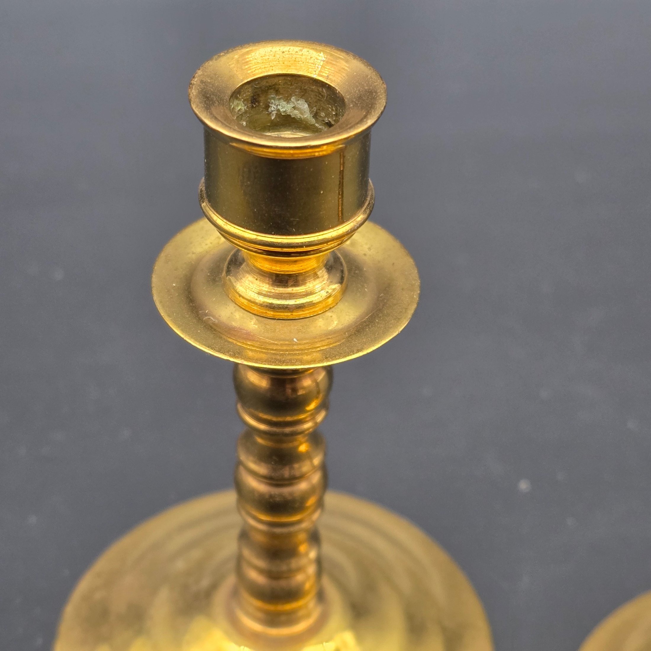 A pair of vintage brass candlesticks, stamped with "Soho Foundry Sovereign Hill Ballarat Australia" and featuring a mining derrick logo, showcasing traditional craftsmanship. - View 4