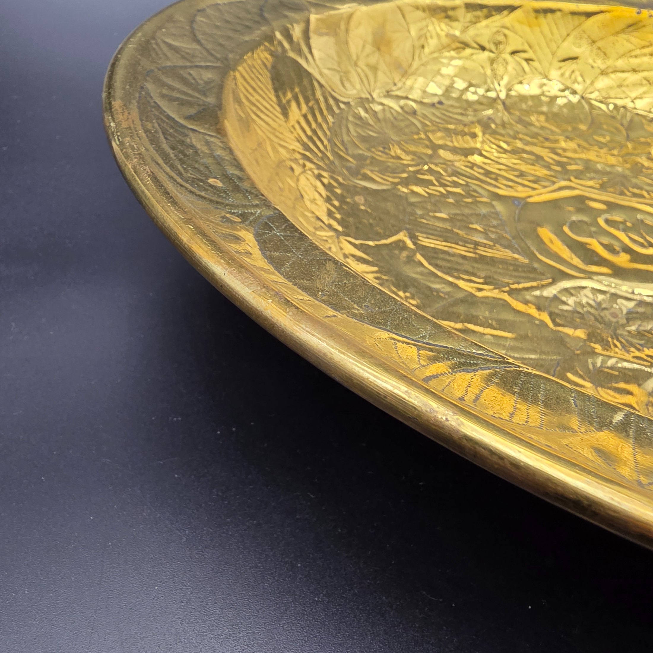 A substantial Victorian decorative basin, meticulously crafted from embossed brass and dated 1880. This piece showcases intricate repoussé and chased patterns, characteristic of the era's decorative metalwork, and would have served as an opulent display item or lavabo basin. - View 6